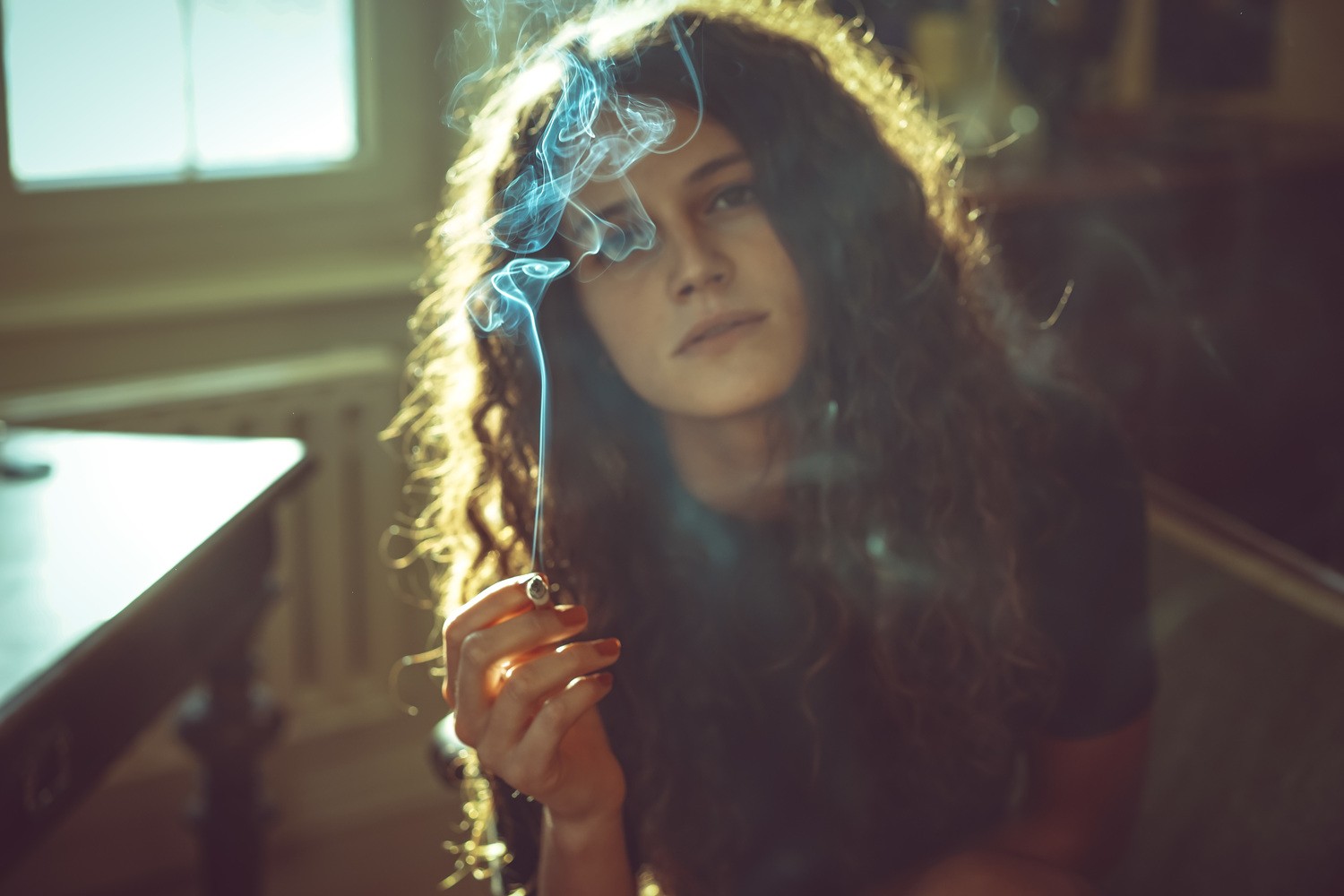 People 1500x1000 women curly hair brunette smoking cigarettes T-shirt women indoors indoors red nails painted nails looking at viewer long hair model