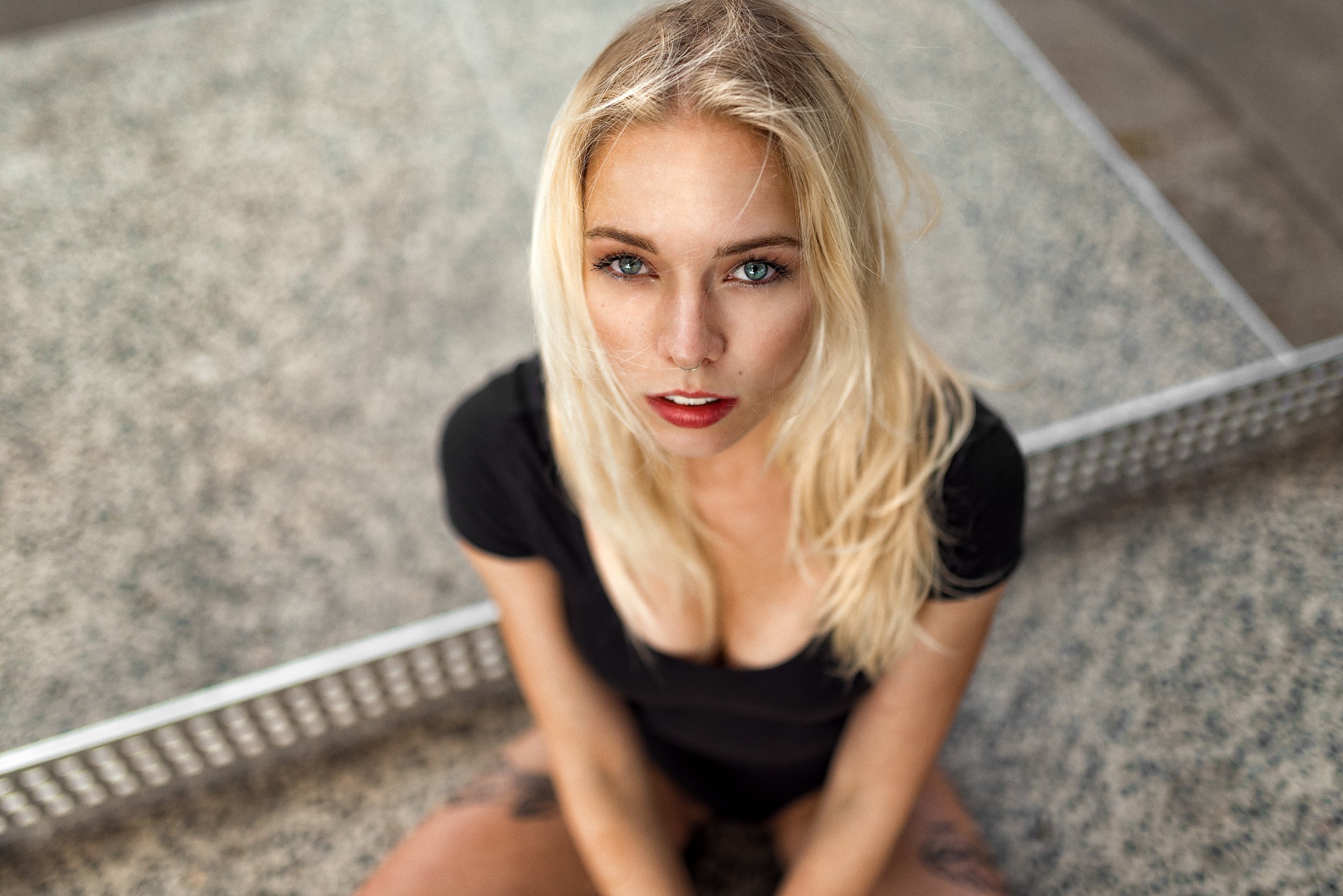 People 2048x1367 women blonde face blue eyes depth of field portrait pierced nose cleavage black clothing tattoo Miro Hofmann looking at viewer nose ring red lipstick long hair Sünni Bressel high angle makeup women outdoors urban sitting bodysuit model closeup