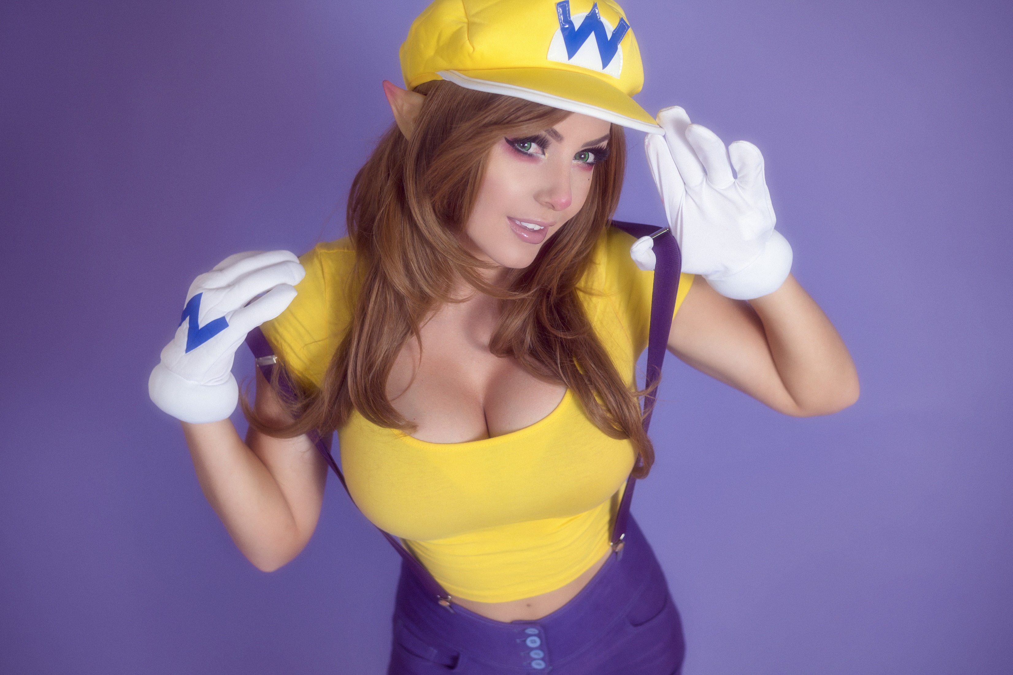 People 3303x2202 Jessica Nigri cosplay Wario Mario Bros. cleavage women yellow tops looking up gloves white gloves boobs big boobs video game girls costumes makeup pointy ears purple background women indoors studio model