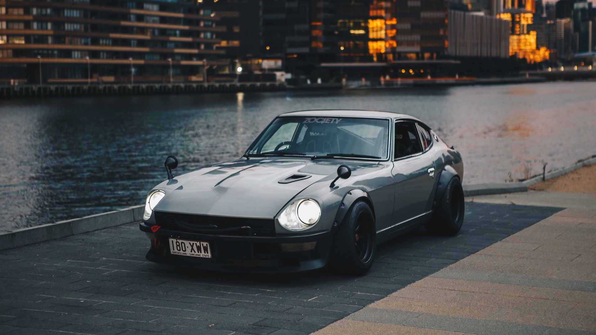 General 1920x1080 Nissan S30 Nissan Fairlady Z Japanese cars sports car Nissan city silver cars car vehicle river frontal view bolt-on fender flares gray cars pavers outdoors