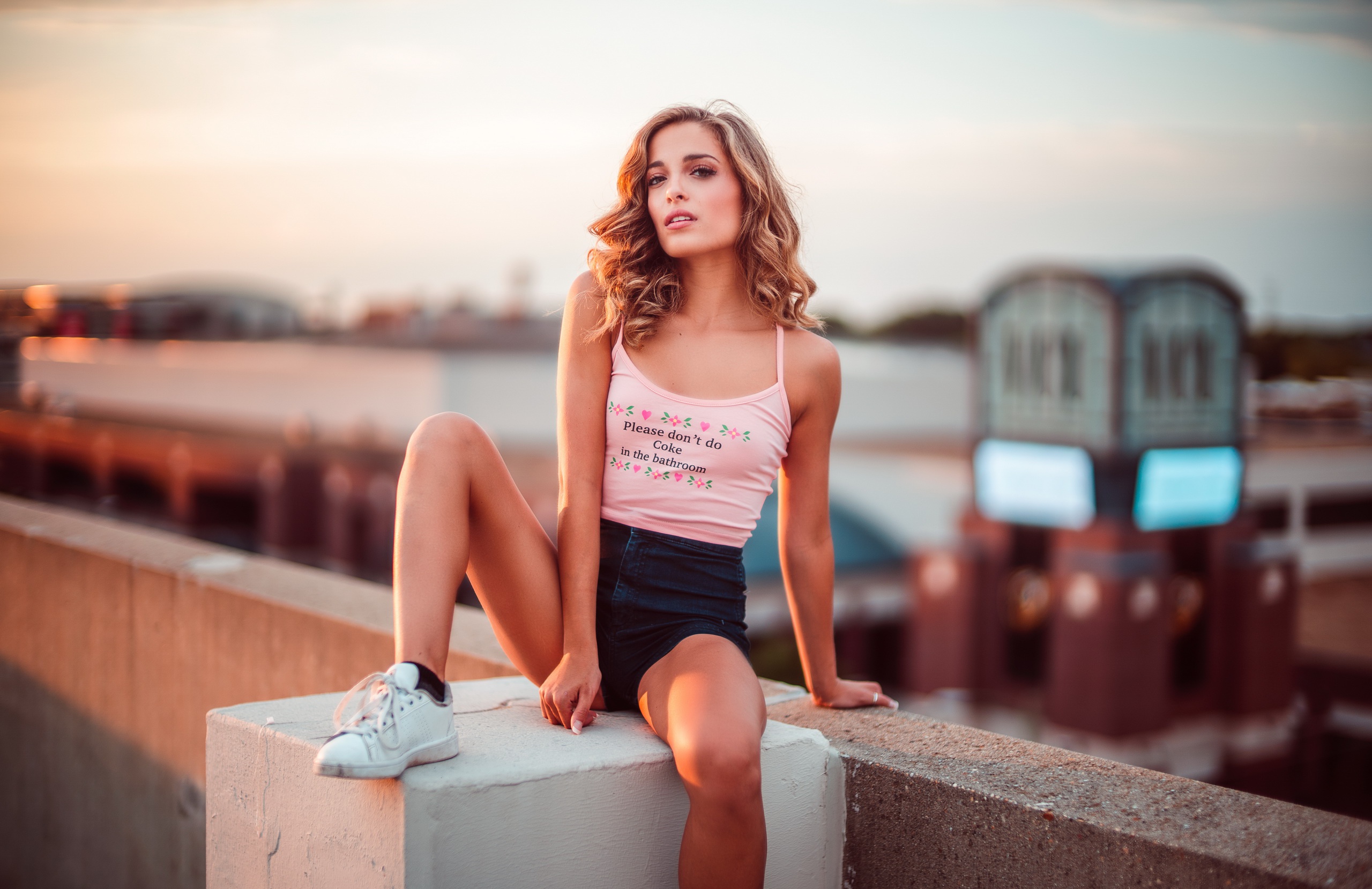People 2560x1658 women model rooftops legs sneakers sitting urban jean shorts tank top blonde long hair white tops high waisted shorts socks black socks  short socks shoes white shoes white sneakers spaghetti straps curly hair women outdoors depth of field looking at viewer