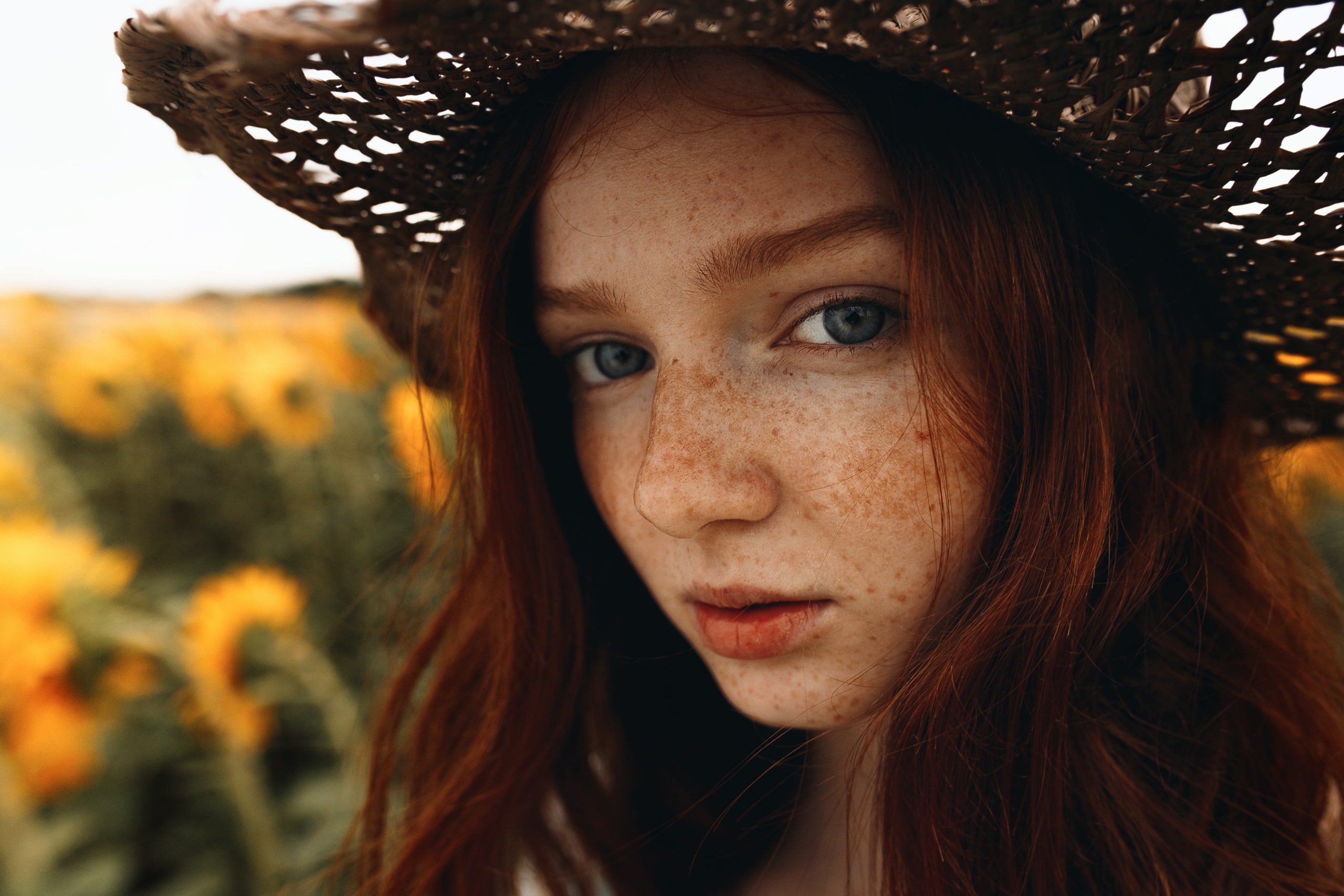 People 2560x1707 Sergey Nevzorov women redhead model looking at viewer face portrait freckles women with hats straw hat women outdoors yellow flowers closeup