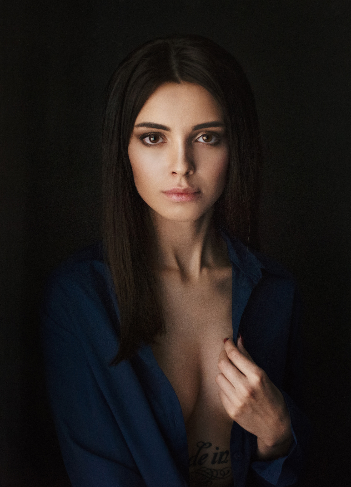 People 1474x2048 Maxim Maximov women Tania Frost dark hair long hair straight hair makeup looking at viewer shirt blue clothing open clothes cleavage tattoo dark portrait blue shirt no bra model brunette studio portrait display simple background low light