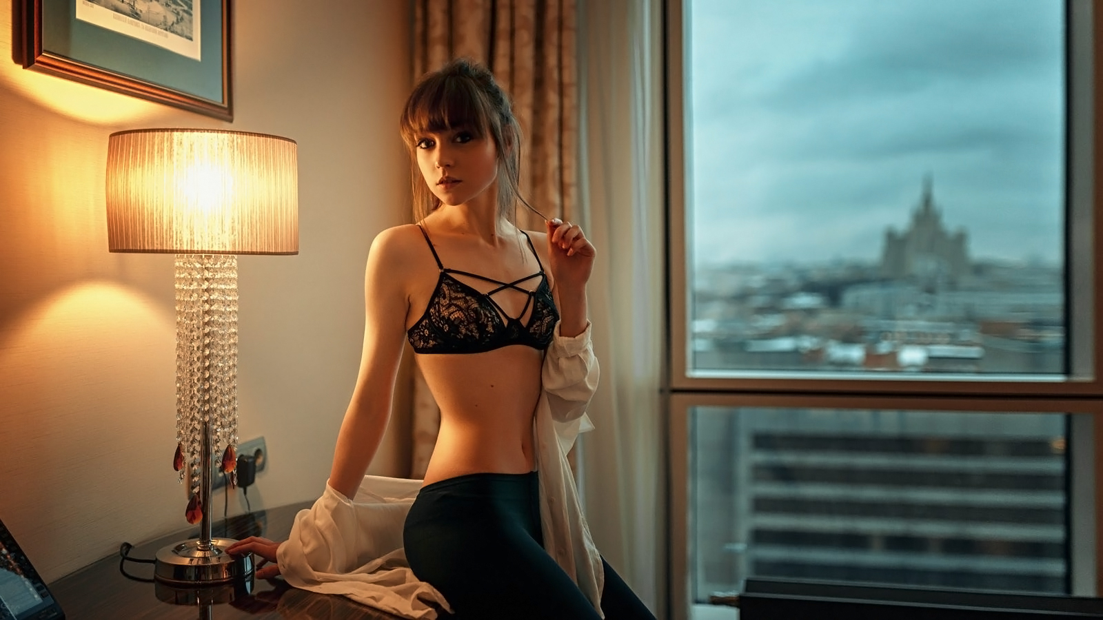 People 1600x900 Georgy Chernyadyev women Olya Pushkina brunette long hair bangs holding hair warm light open clothes shirt white clothing pants lingerie bra straps window women indoors indoors belly black bras lamp room looking at viewer Moscow Russia
