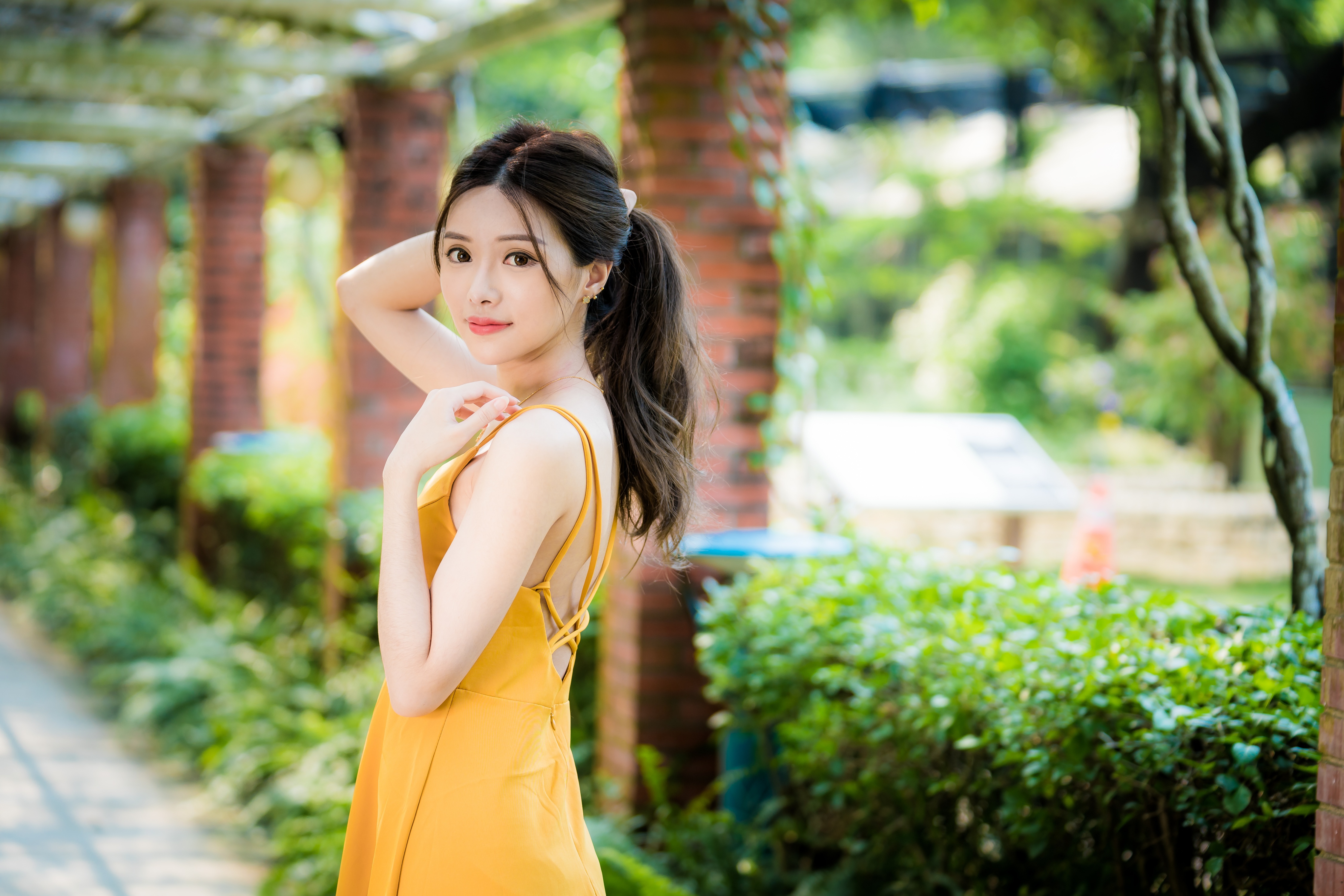 People 4500x3002 Asian women model depth of field long hair brunette bricks column yellow dress bushes ponytail