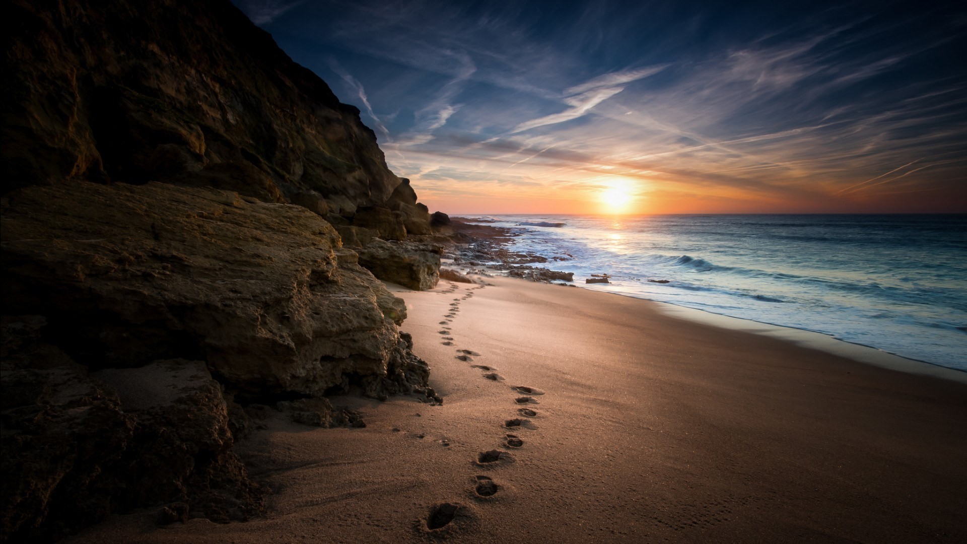 General 1920x1080 nature landscape sea coast sand footprints rocks Sun clouds cliff horizon