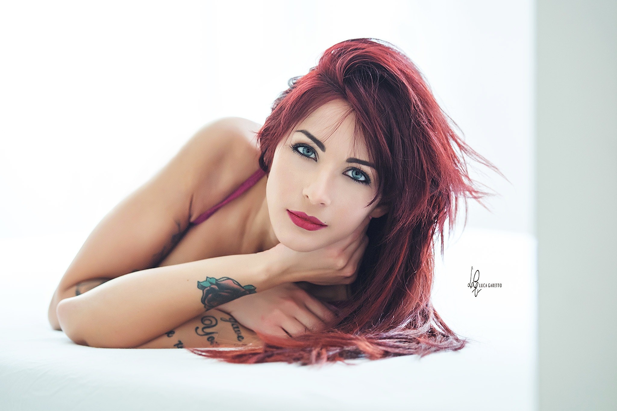 People 2048x1365 women redhead face blue eyes tattoo pink bra red lipstick eyeliner simple background lying on side