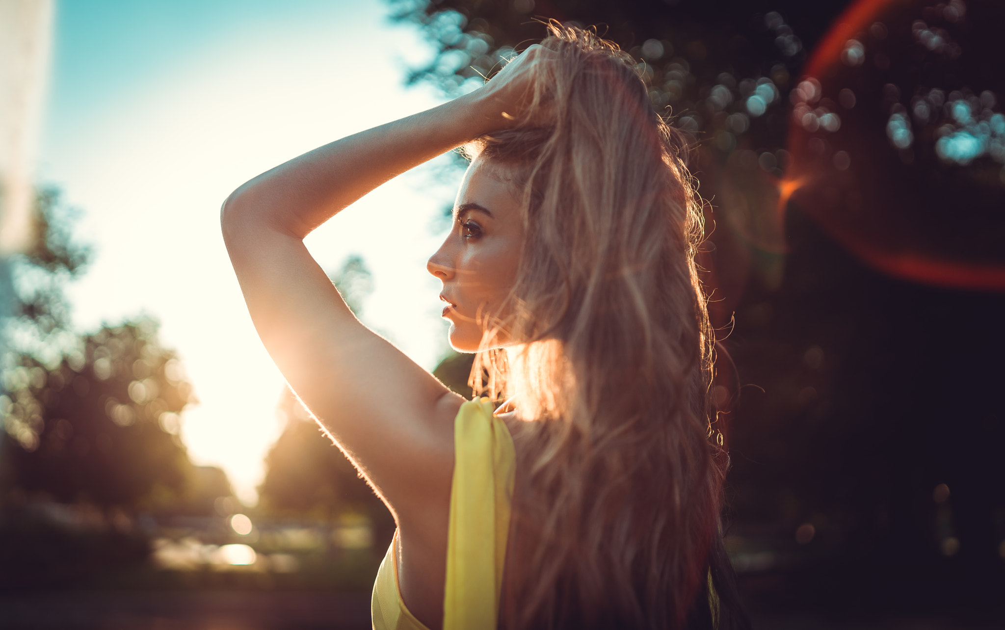 People 2048x1284 women blonde face long hair women outdoors dress tanned back lens flare hands in hair looking into the distance profile bokeh Marco Squassina