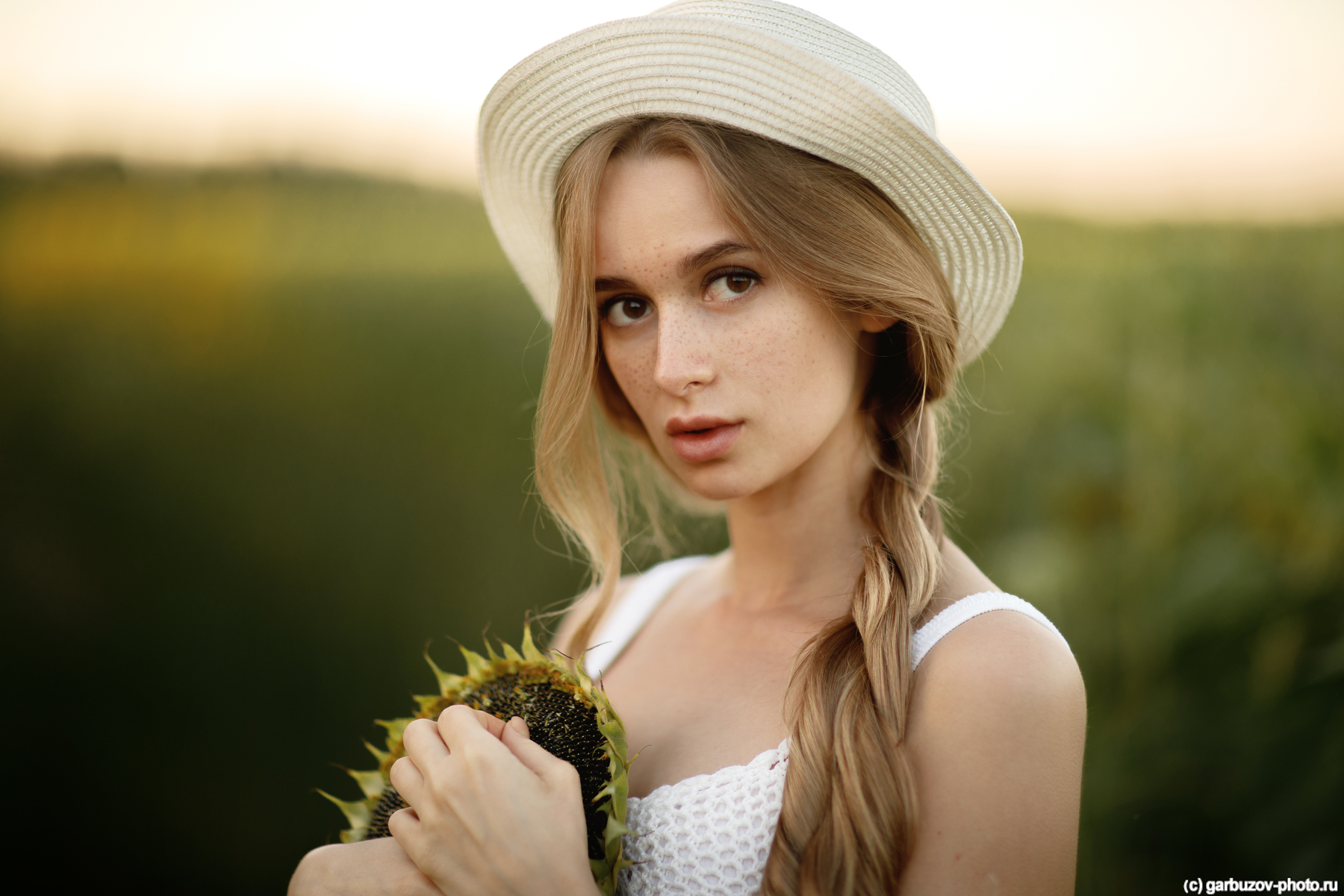 People 1800x1200 women blonde model long hair women with hats looking at viewer brown eyes freckles portrait white dress dress sunflowers depth of field outdoors women outdoors Ilya Garbuzov face closeup green background plants flowers hat