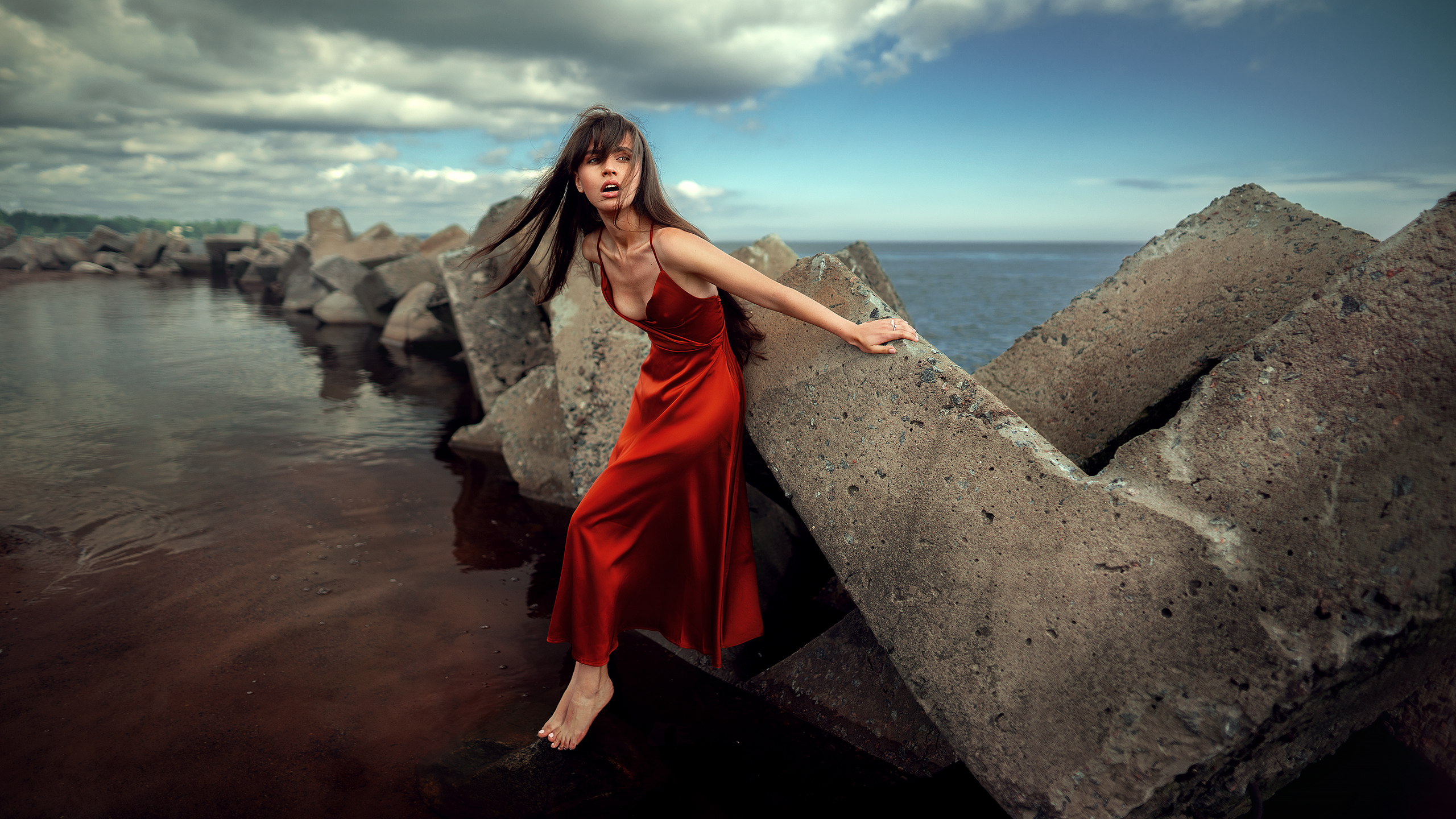 People 2560x1440 red dress women women outdoors water concrete brunette barefoot photography model long hair open mouth pointed toes
