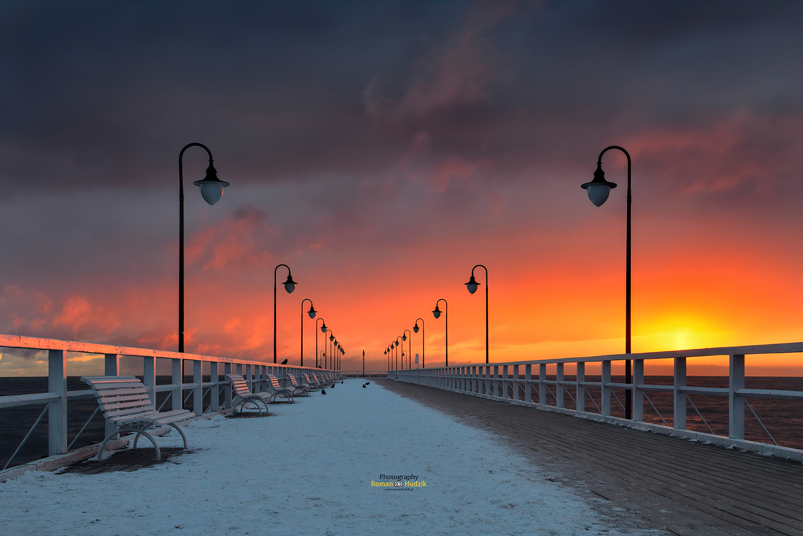 General 1600x1068 pier birds sunset snow covered winter photography outdoors warm light bench street light Roman Hudzik