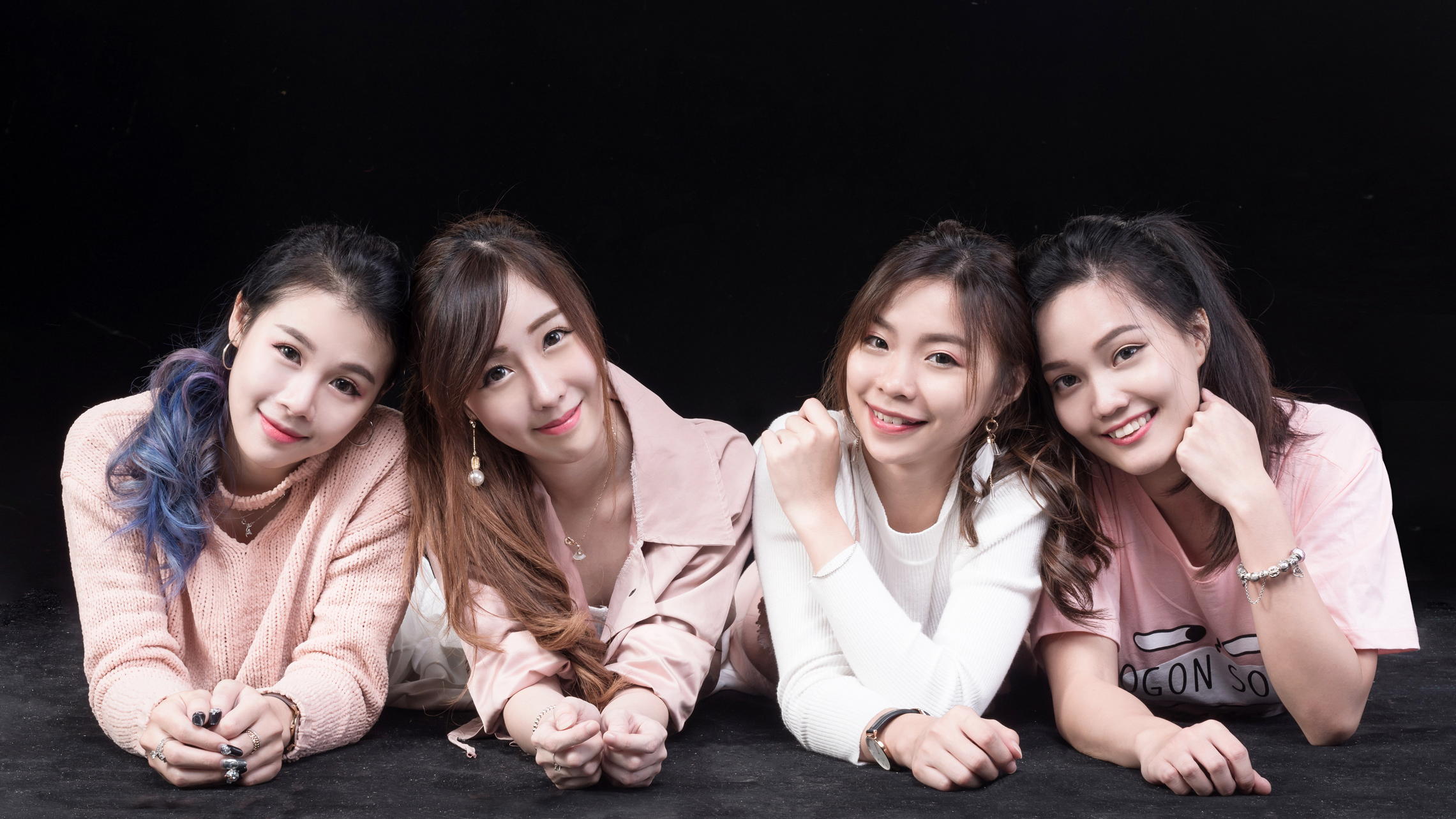 People 2281x1283 Asian model women lying down long hair brunette dyed hair ponytail bracelets necklace wristwatch earring painted nails pullover shirt black background group of women smiling