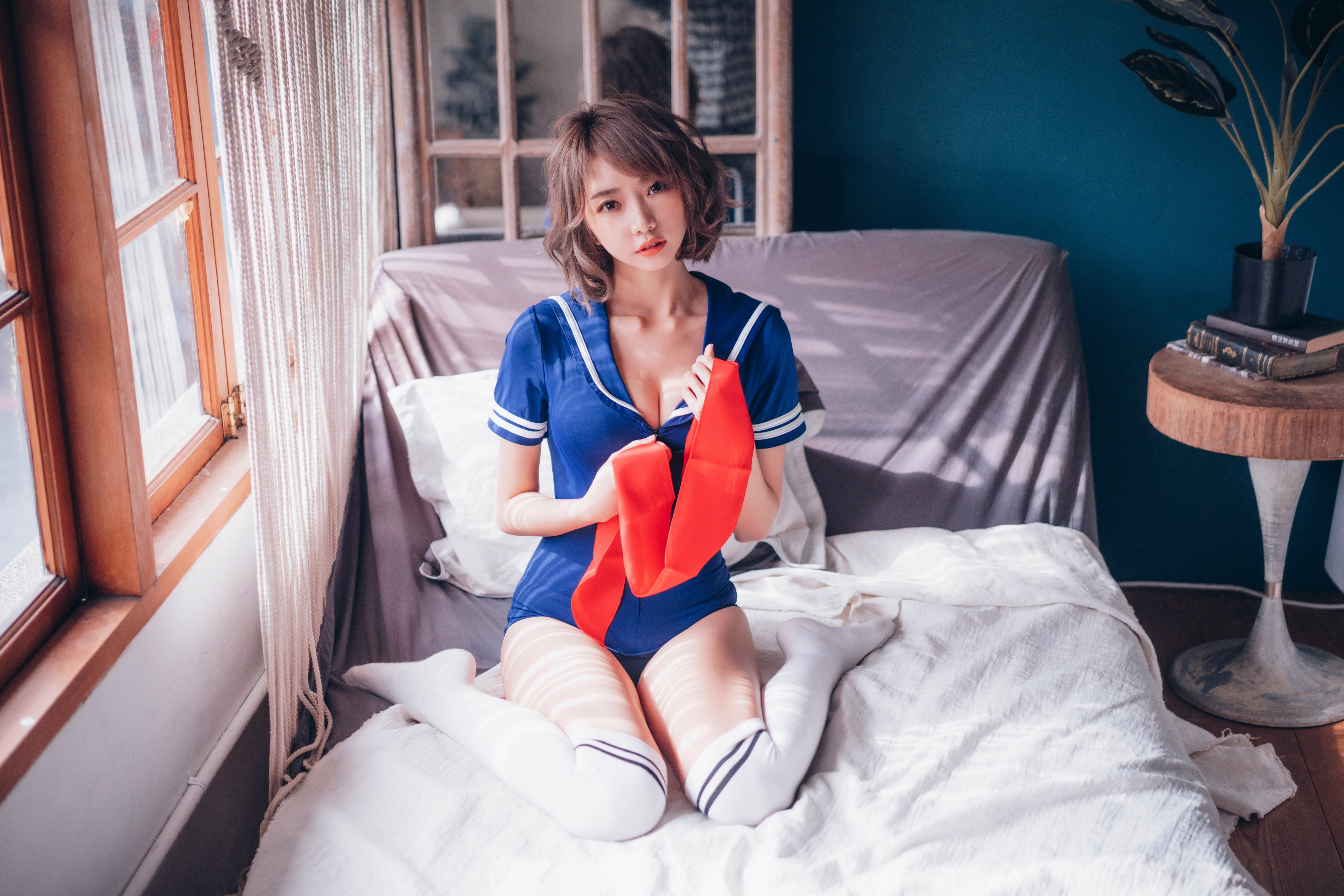 People 3840x2561 Asian model women brunette sitting bed pillow curtains window sailor uniform table plant pot books sheets looking at viewer scarf natural light cawaiiun socks white socks OTK socks striped socks pointed toes parted lips