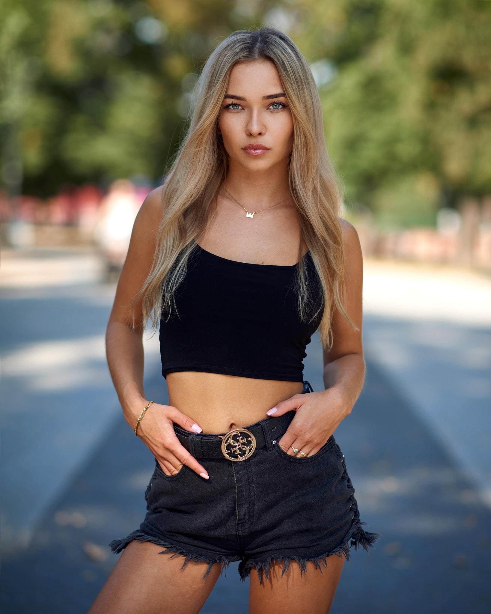 People 1638x2048 Bulinko Piotr women blonde long hair looking at viewer jewelry gold necklace tank top black clothing bracelets shorts hands in pockets outdoors depth of field black top short tops frontal view