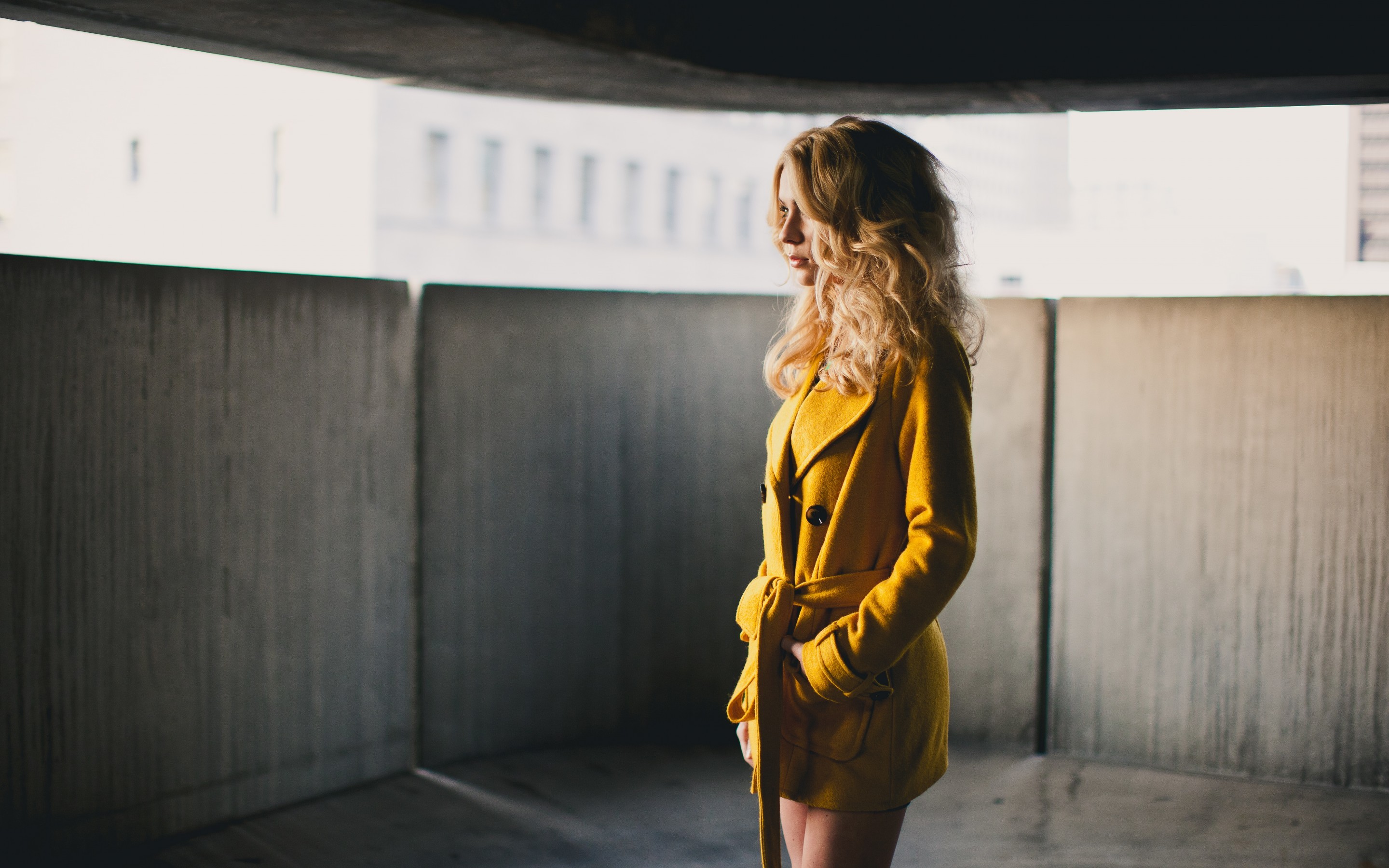People 2880x1800 women model long hair blonde coats curly hair depth of field yellow coats hands in pockets standing looking into the distance legs together yellow clothing women indoors indoors fashion Alexis Coons