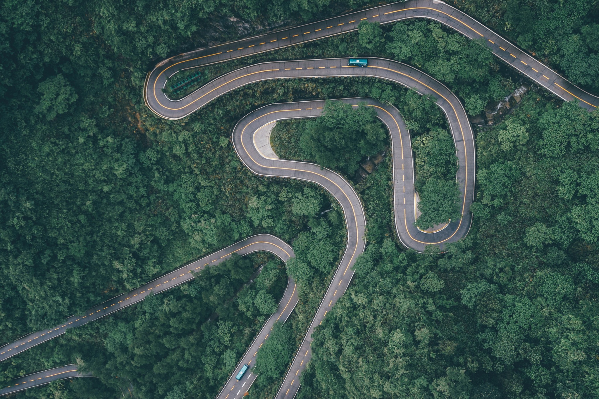 General 2048x1365 forest road car buses river green asphalt highway China trees hairpin turns aerial view