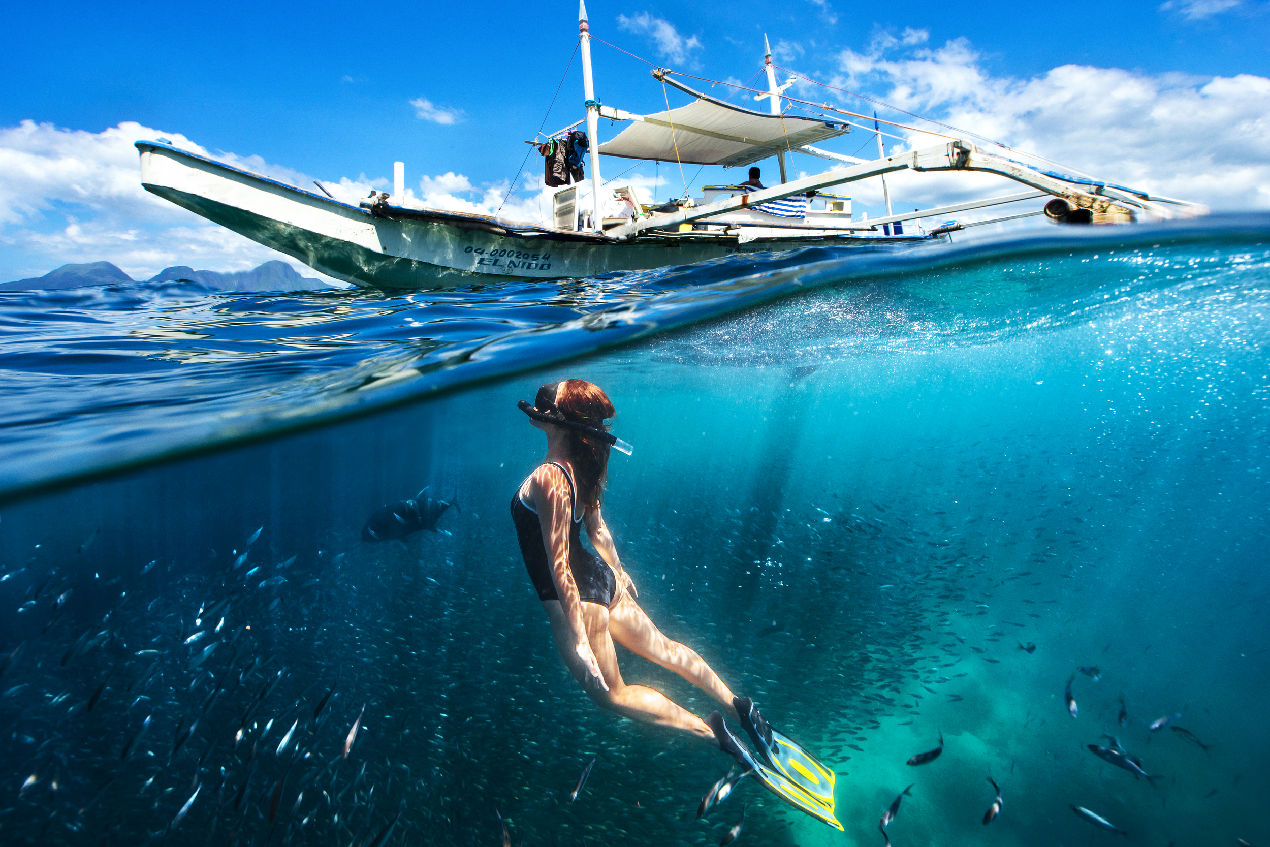 People 2500x1667 underwater boat sea nature women Paul Toma Philippines divers fish cyan blue swimming