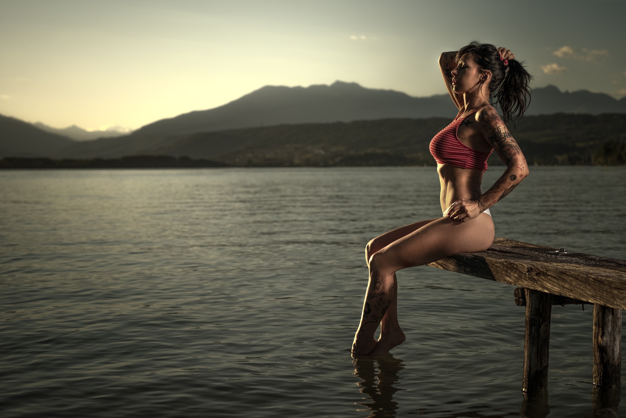 People 2048x1367 women closed eyes ass tattoo water hands on head sitting brunette painted nails lake mountains sky thong sunset outdoors model inked girls