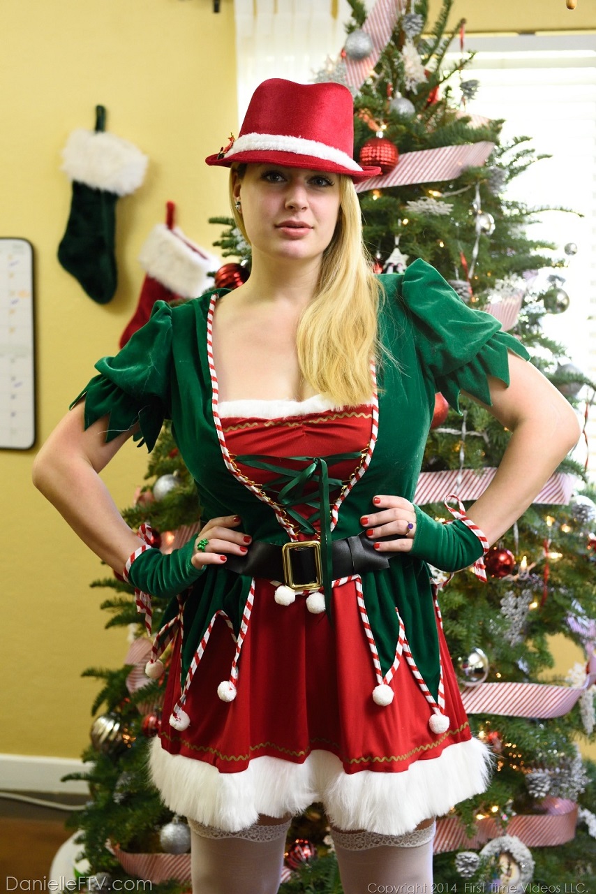 People 854x1280 Danielle Delaunay women indoors FTV Girls portrait display women indoors Christmas Christmas tree standing Christmas ornaments  hair   Christmas clothes long hair hands on hips gloves watermarked socks hat looking at viewer red nails painted nails stockings 2014 (Year)