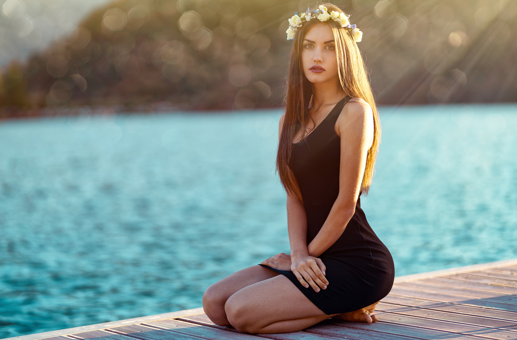 People 2048x1346 women kneeling Marco Squassina bokeh sea black dress long hair wreaths brunette lens flare sun rays looking at viewer tight dress tight clothing straight hair flower in hair open mouth red lipstick portrait dress