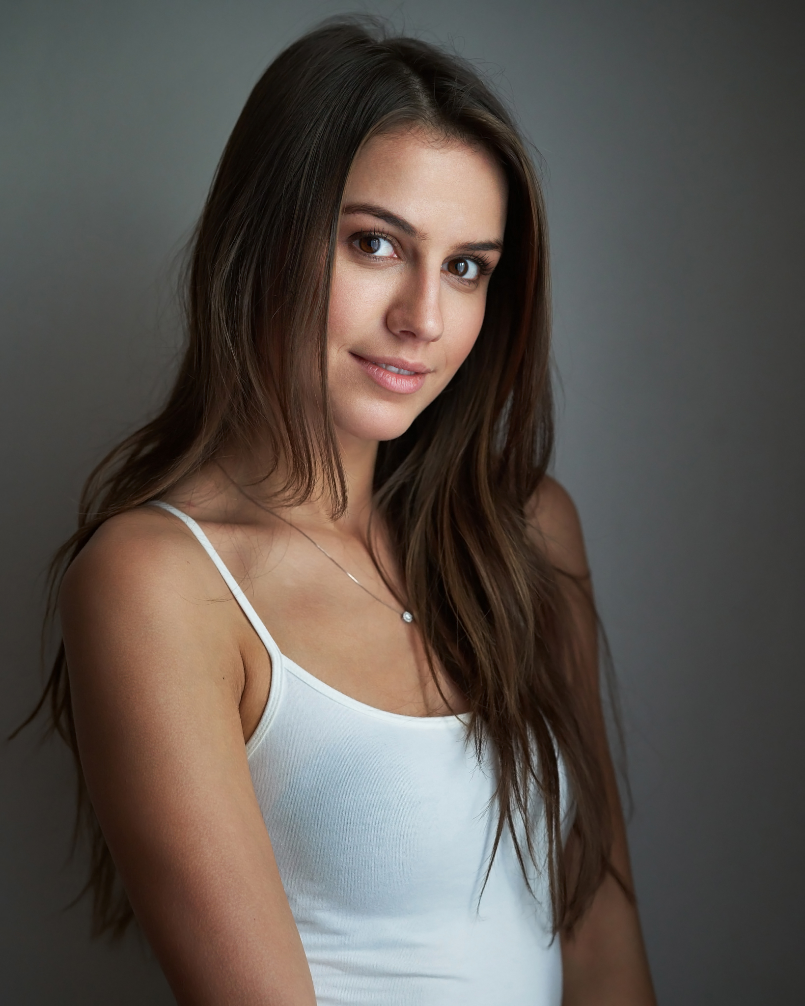 People 1639x2048 Milan R women brunette long hair straight hair brown eyes looking at viewer smiling tank top white clothing jewelry necklace simple background studio women indoors indoors white tank top portrait