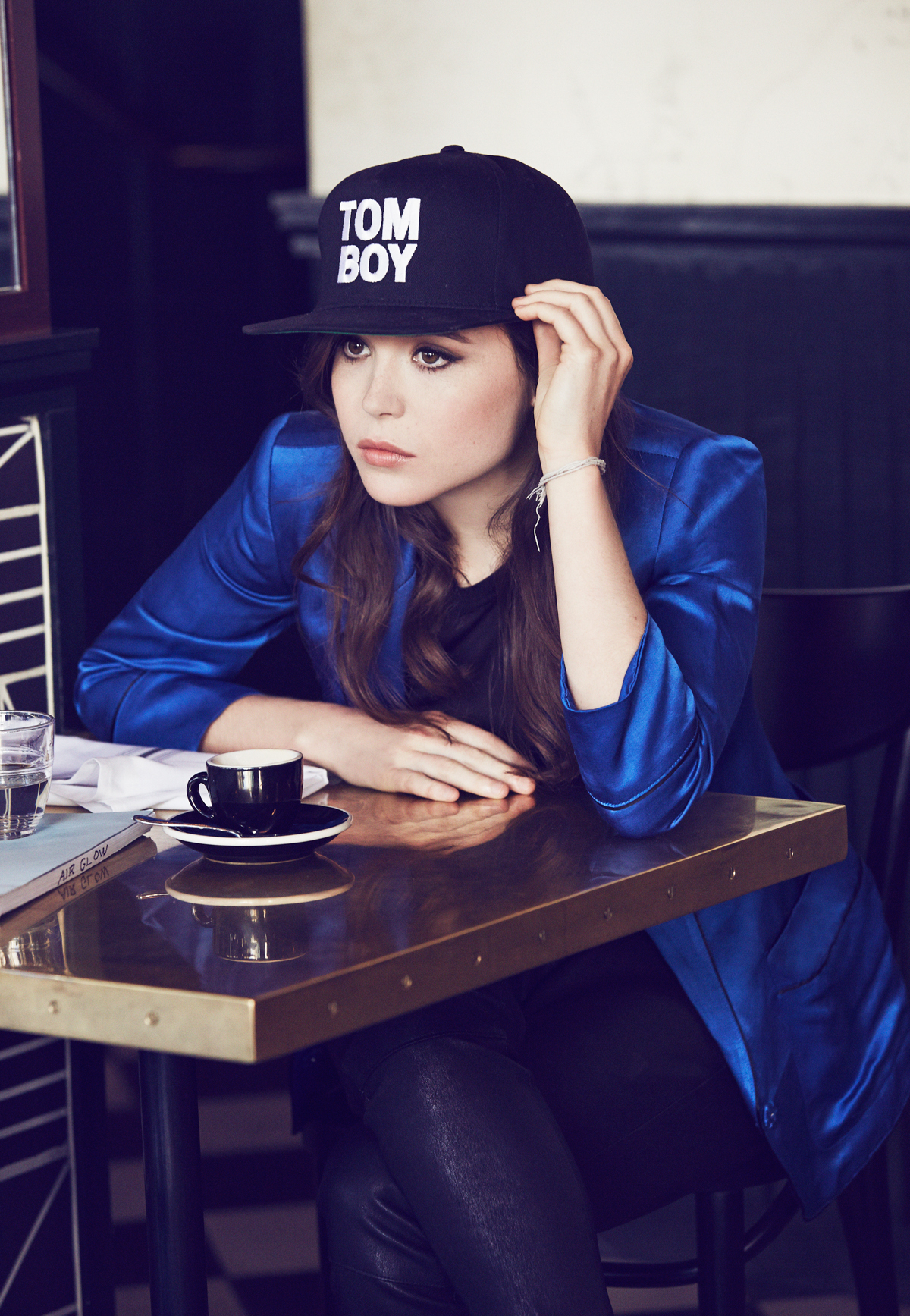 People 1200x1735 actress women Elliot Page portrait display brunette dark hair long hair blue jacket women with hats hat celebrity looking away sitting cup table reflection closed mouth jacket