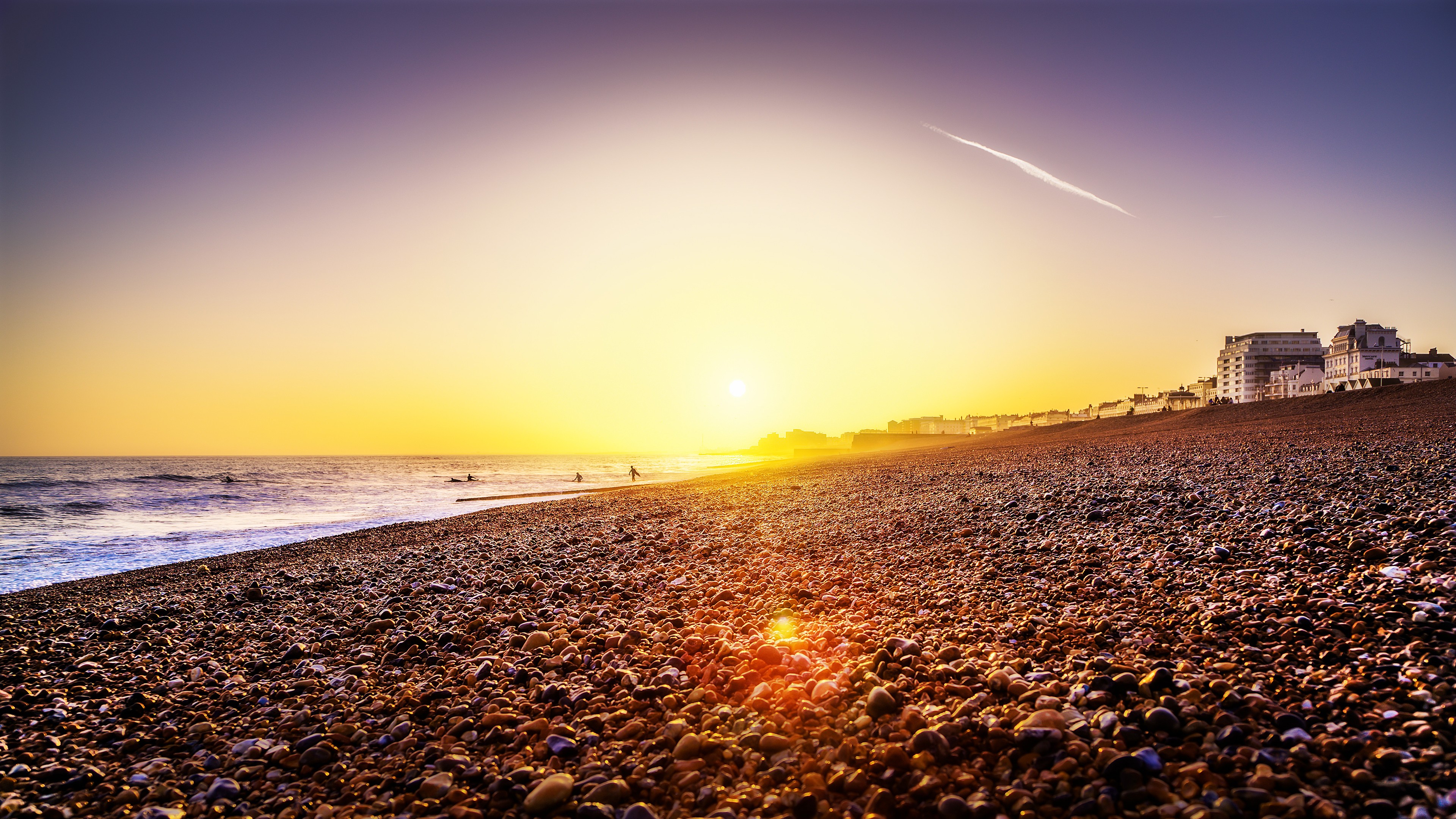 General 3840x2160 landscape sea beach stones orange sky pebbles lens flare contrails sunset
