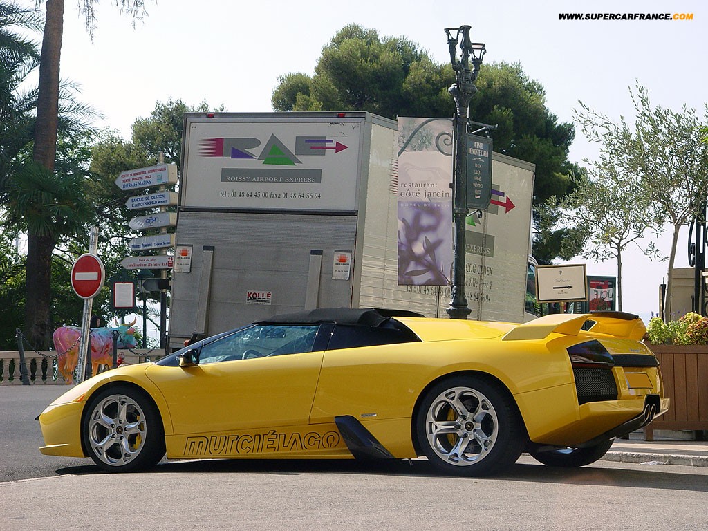 General 1024x768 car yellow cars Lamborghini vehicle sign urban watermarked Lamborghini Murcielago italian cars Volkswagen Group