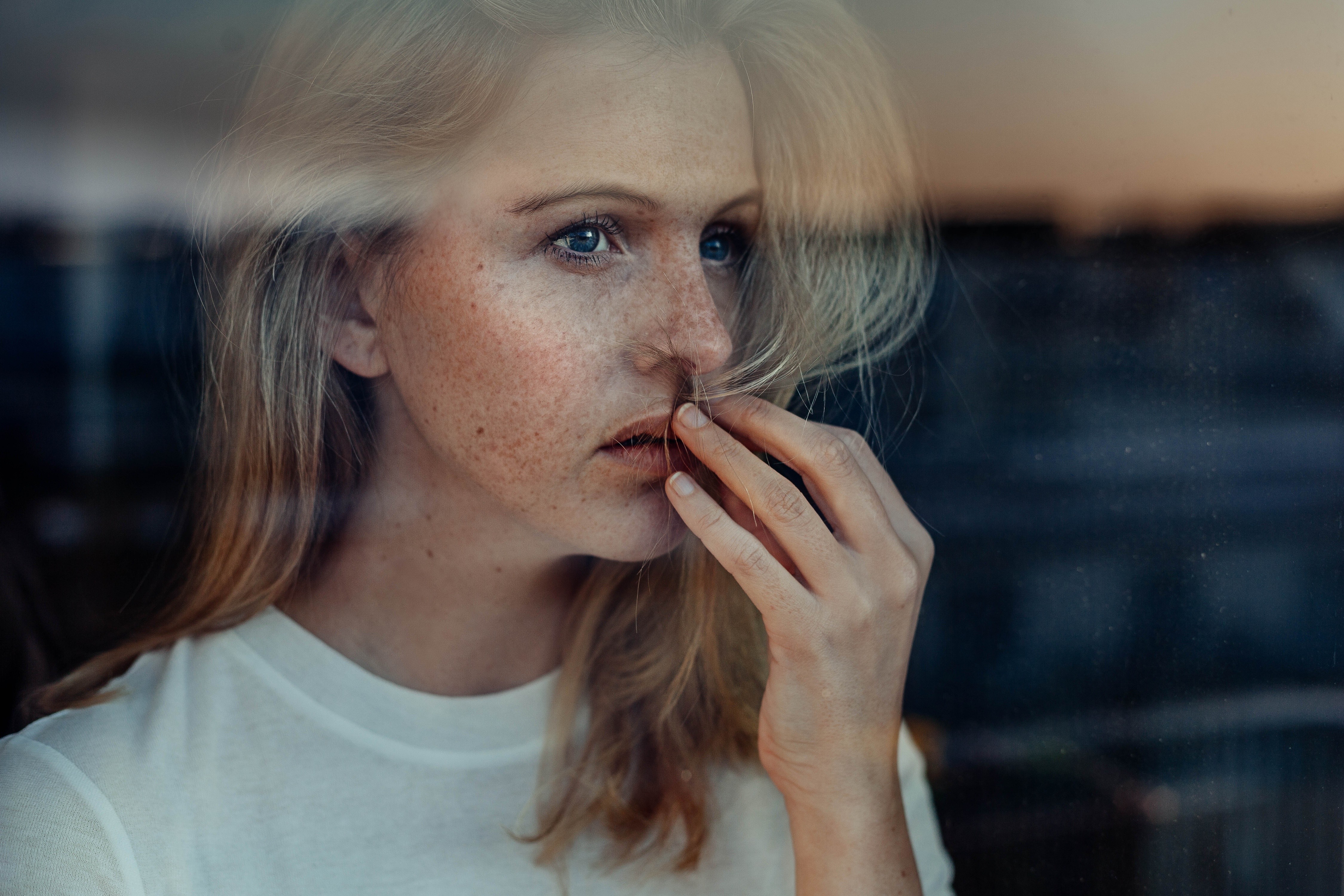 People 4500x3000 women model blonde blue eyes long hair looking out window white tops freckles hair in face thinking sadness reflection T-shirt