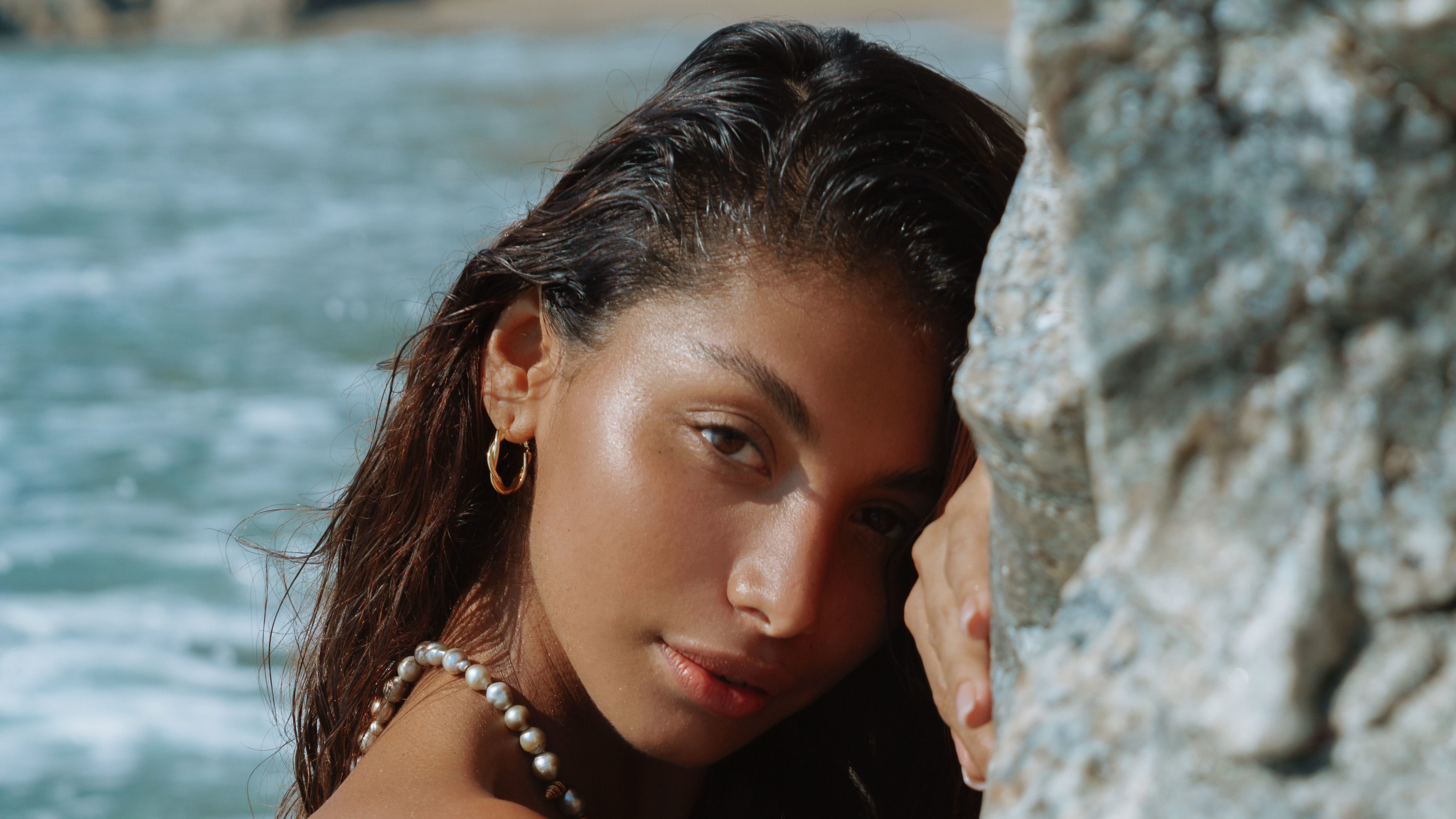 People 3840x2160 Carolina Reyes women women outdoors seashore looking at viewer rocks wall sensual gaze face closeup