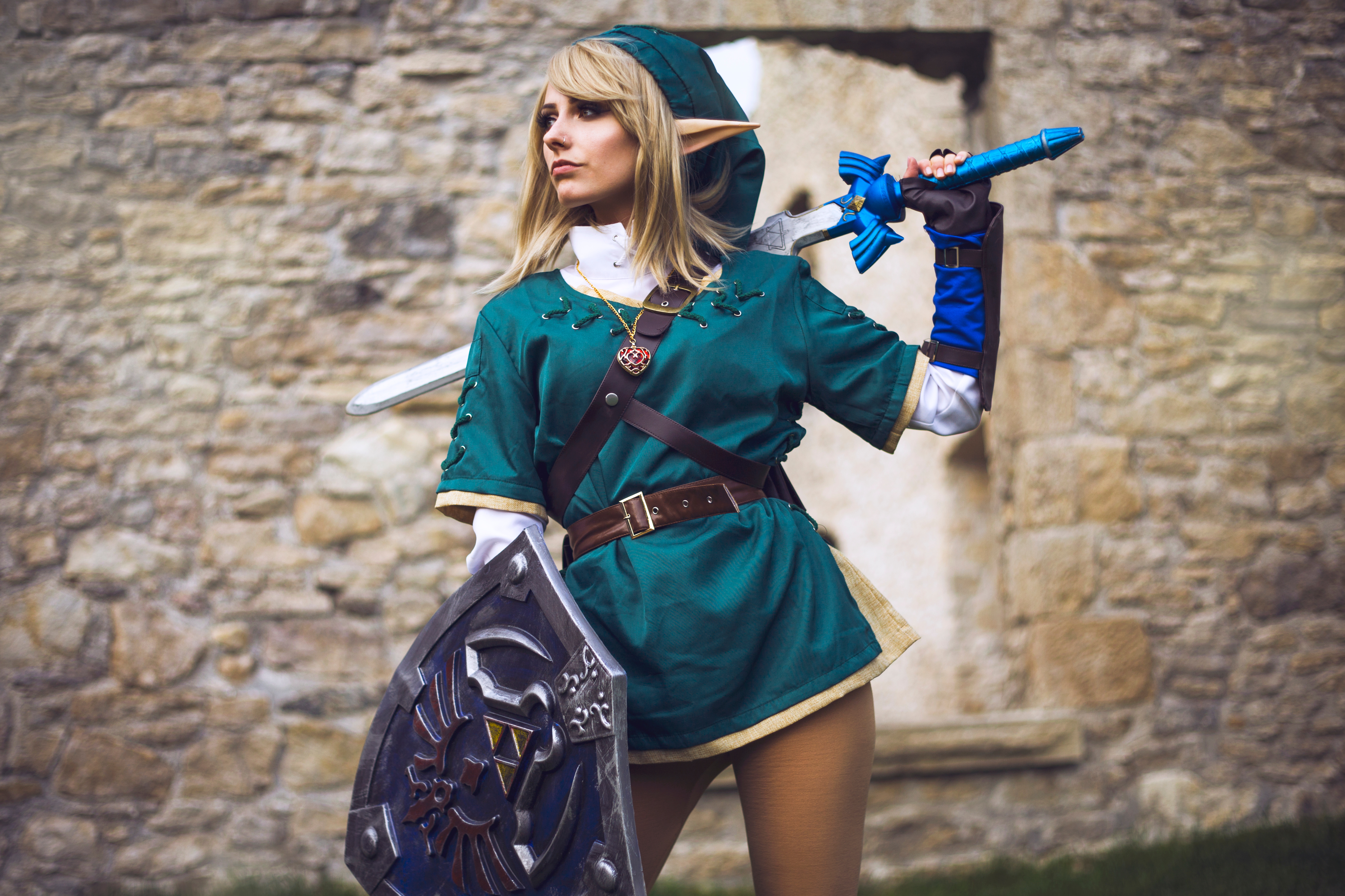 People 6405x4270 Taylor Bloxam women cosplay The Legend of Zelda Link sword shield pointy ears looking away medallion model nose ring video game characters women with swords girls with guns women outdoors blonde green tunic