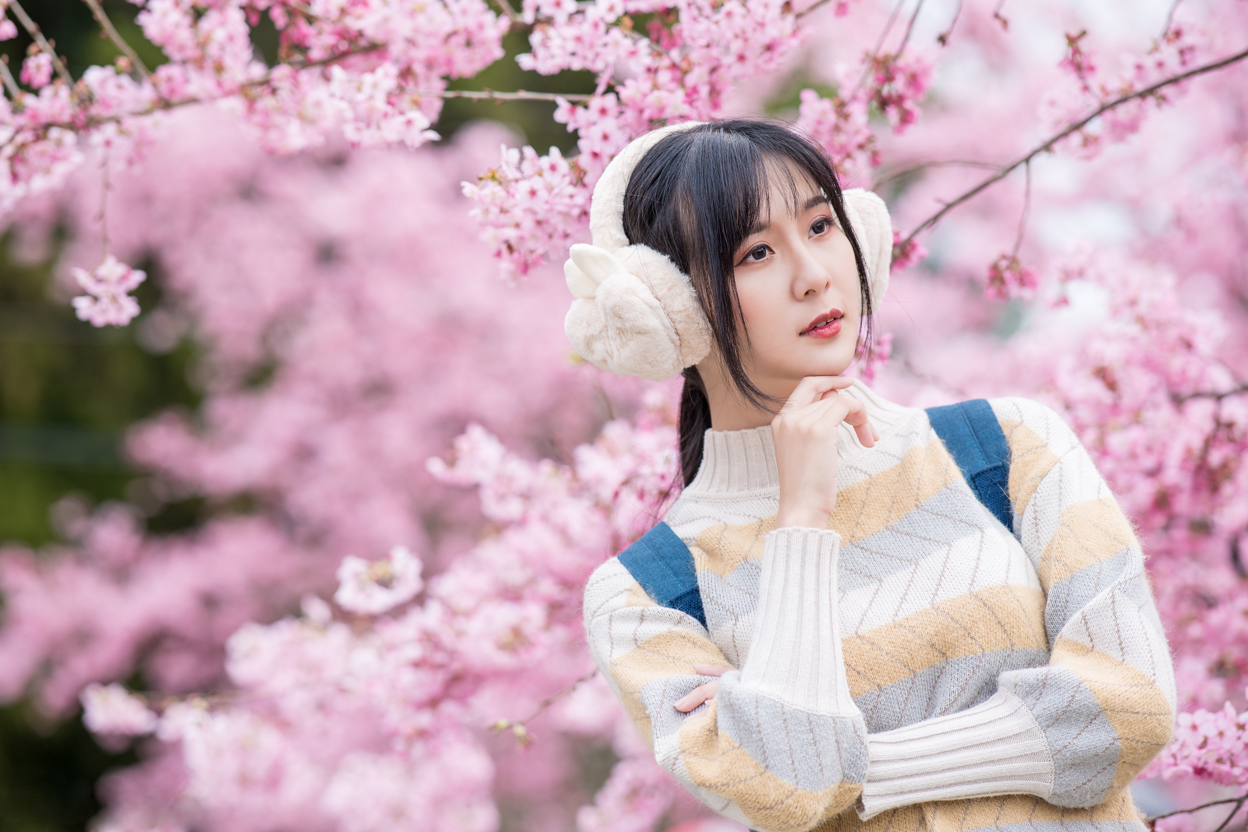 People 4096x2730 Asian model women depth of field long hair brunette cherry blossom pullover backpacks ponytail ear muffs looking into the distance trees