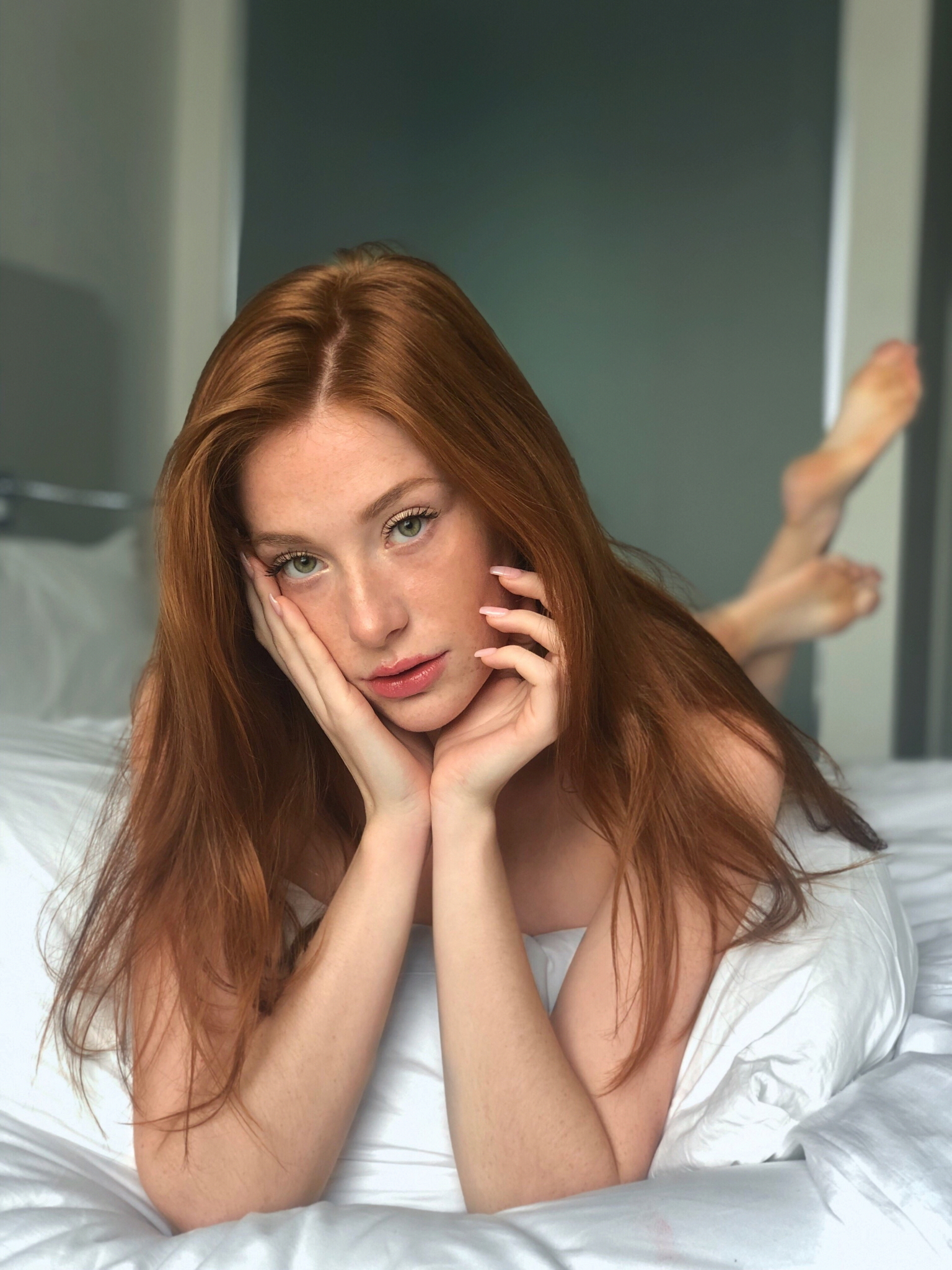 People 1536x2048 Madeline Ford women redhead model long hair freckles looking at viewer parted lips touching face lying on front barefoot in bed depth of field bedroom portrait display indoors women indoors