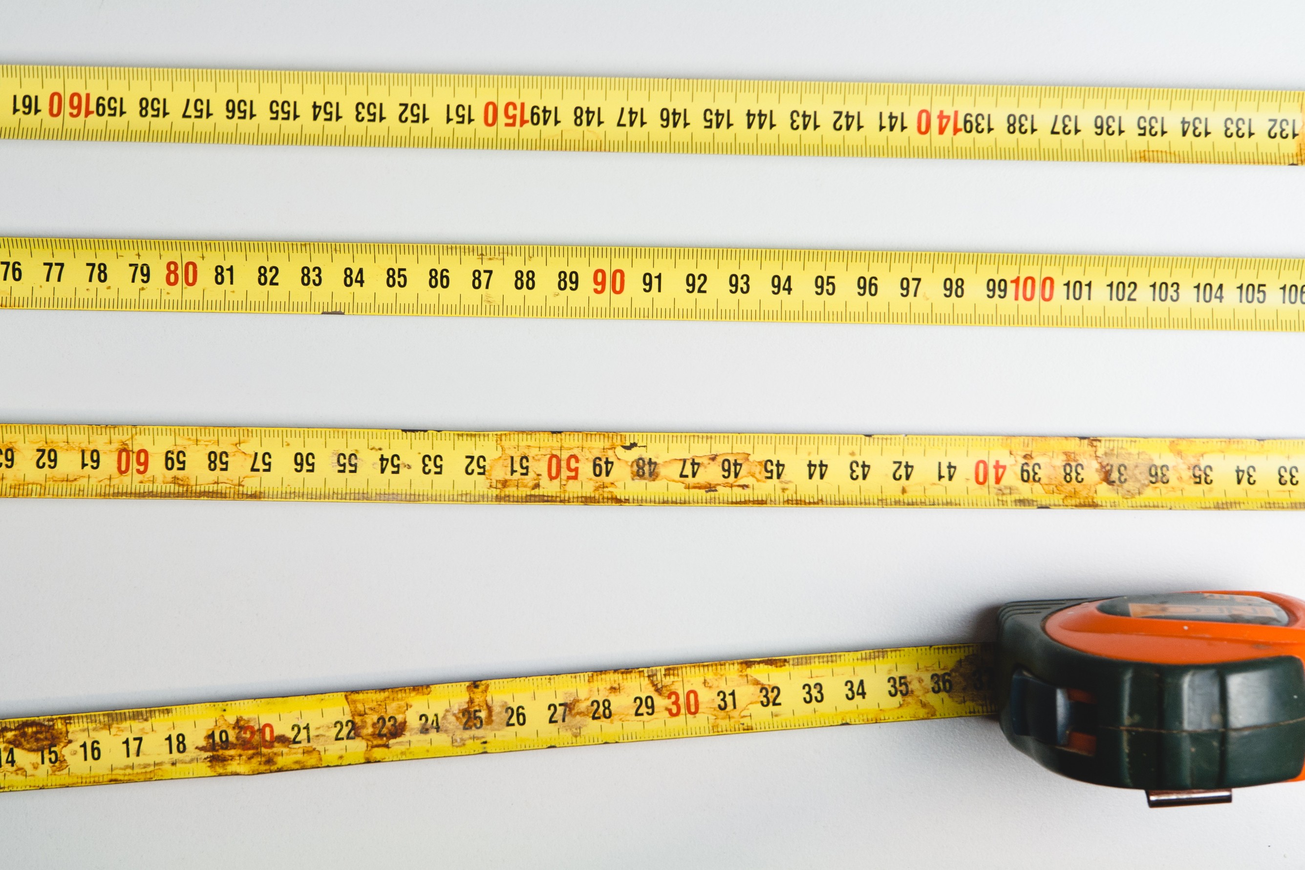 General 2671x1781 measuring tape rust white background numbers