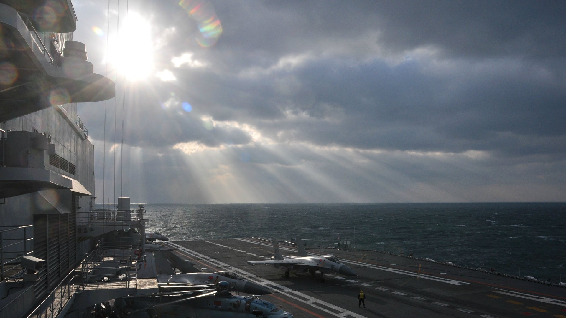 General 1920x1080 aircraft carrier flight deck People's Liberation Army Navy sea warship navy China Sun sunlight crepuscular rays clouds shining sun rays Sukhoi Su-30 jet fighter