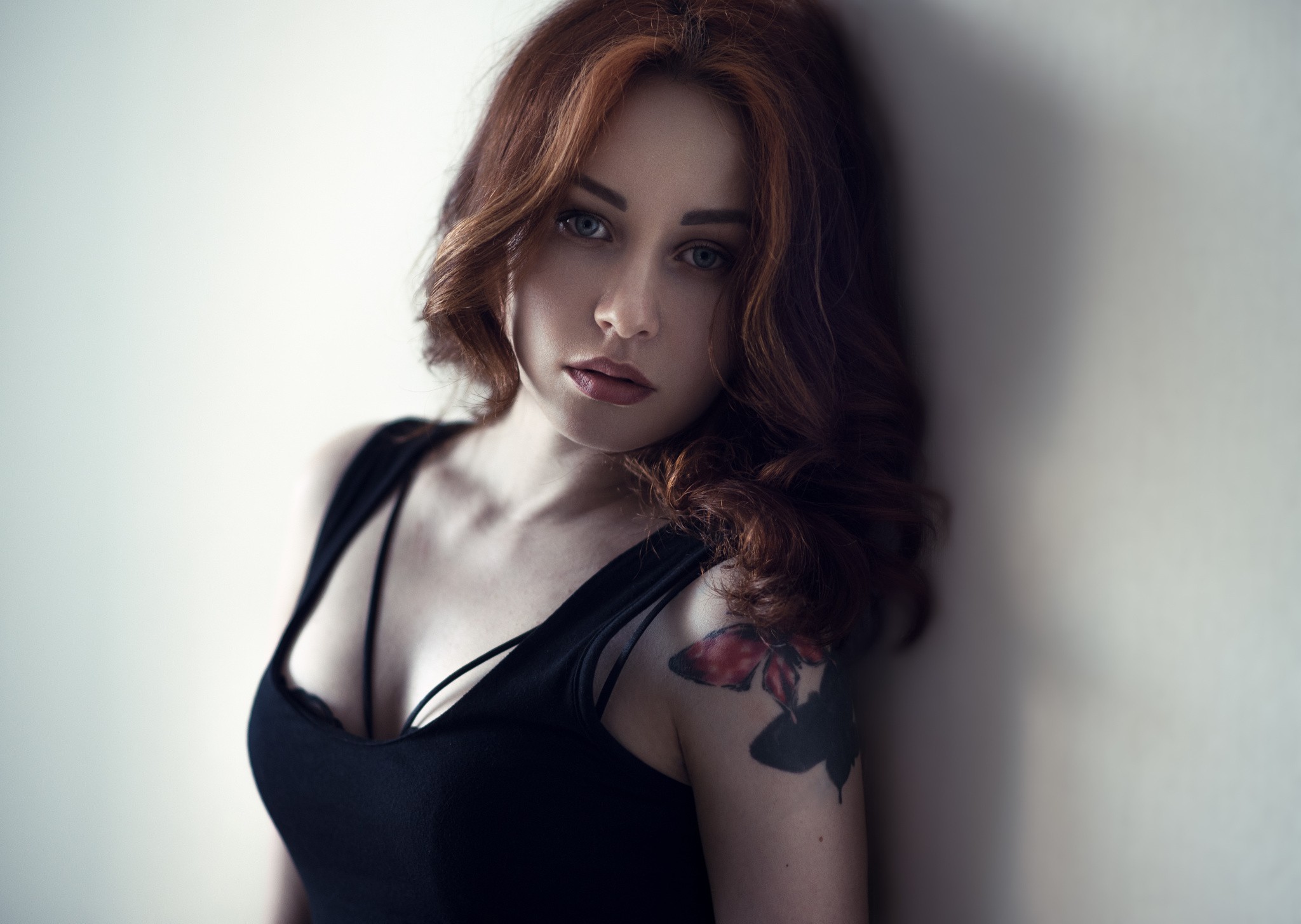 People 2048x1456 women redhead tattoo blue eyes face portrait black clothing pale black bras women indoors inked girls makeup red lipstick dyed hair looking at viewer wall simple background Andrey Firsov