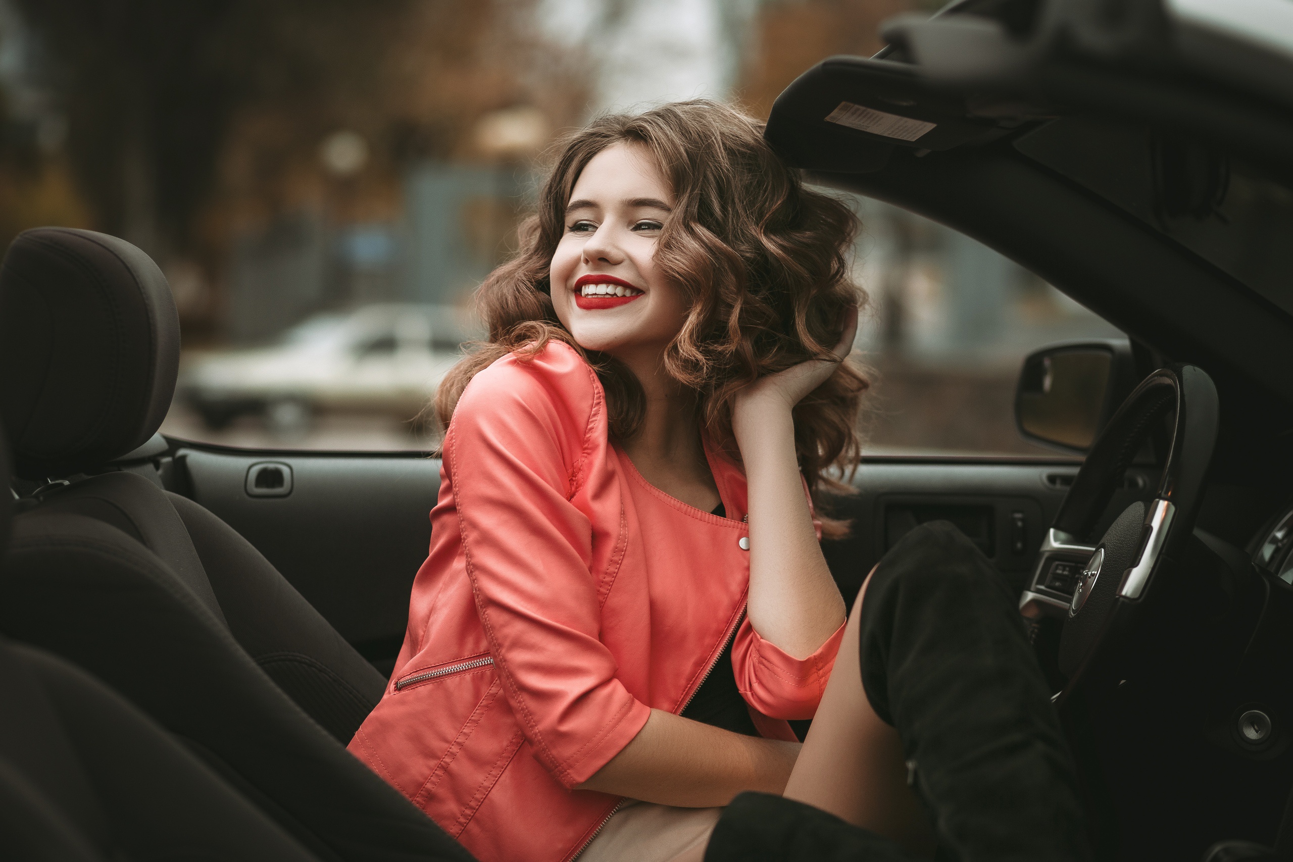 People 2560x1707 model red lipstick smiling orange clothing hands in hair spiral hair women with cars women outdoors brunette