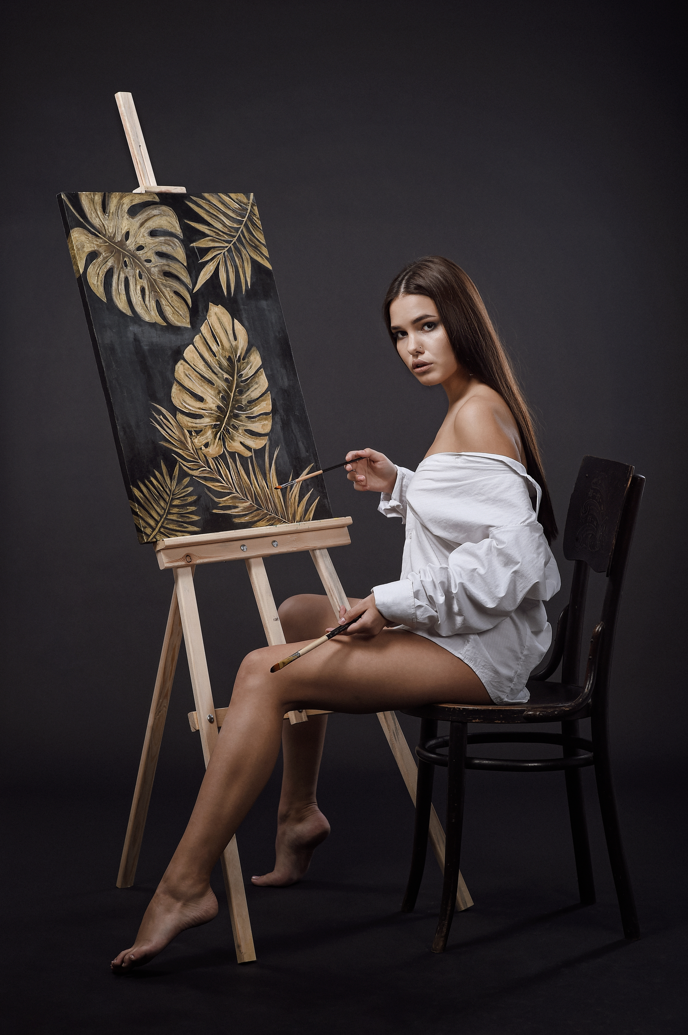 People 2329x3500 women model brunette long hair women indoors chair painting barefoot shirt bare shoulders looking at viewer sitting portrait display legs paint brushes painters Sergei Roubanov simple background easel pointed toes
