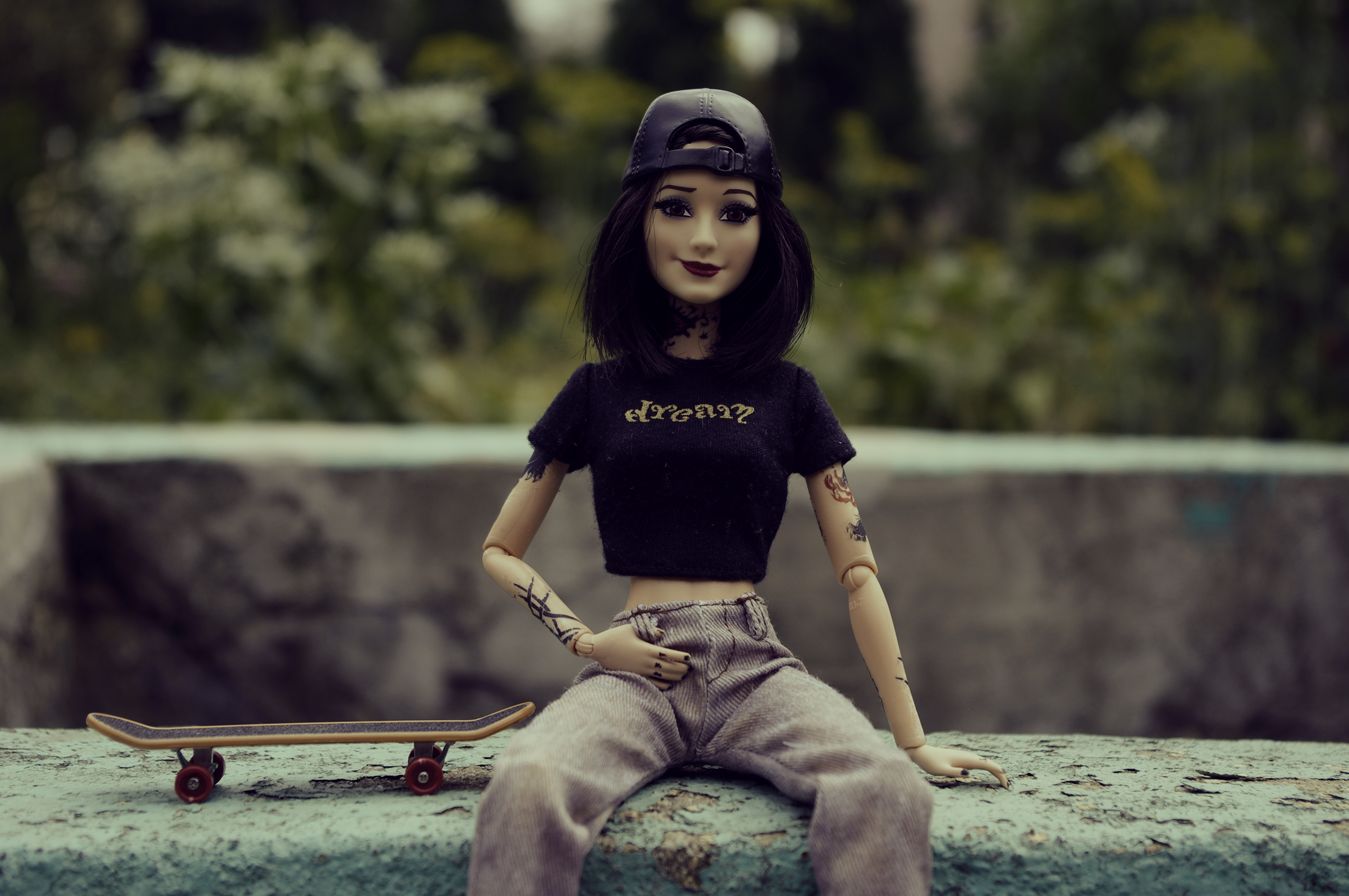 General 3000x1993 Barbie doll toys hat leather dark hair tattoo skateboard skateboarding looking at viewer smiling blurred blurry background