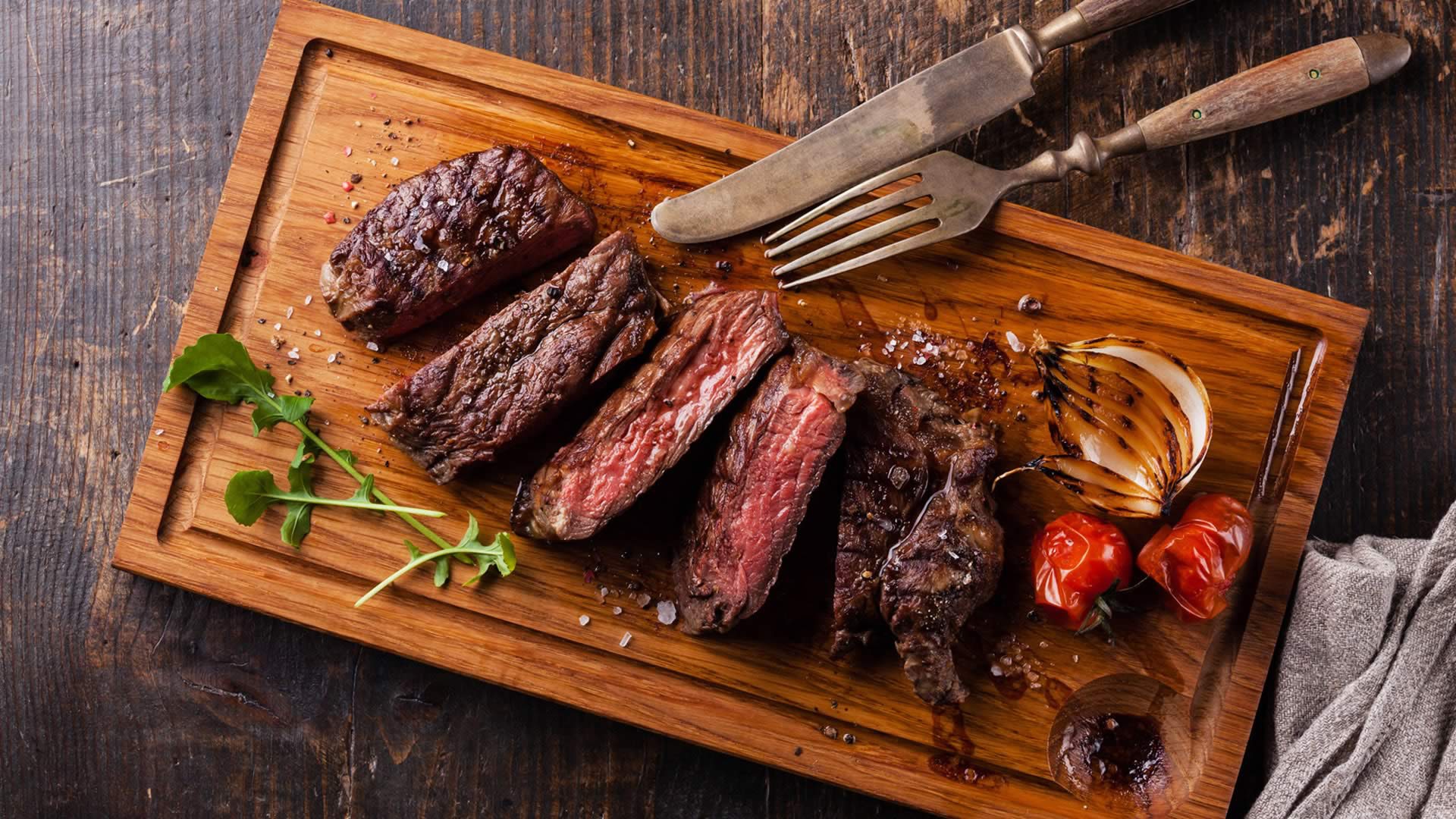 meat, food, steak, wood, tomatoes, onion, table knife, fork, salt