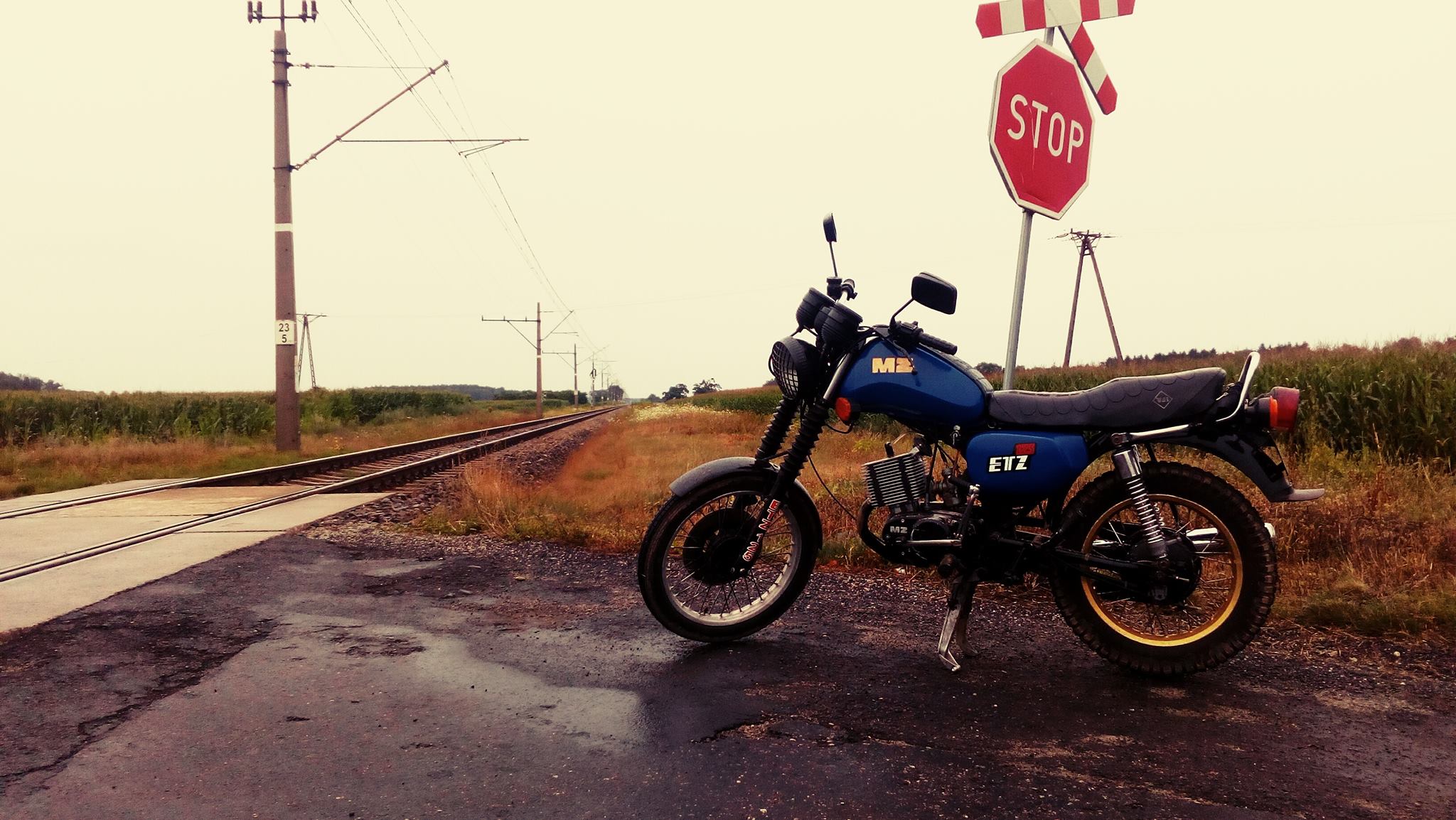 General 2048x1154 motorcycle rain railway wet street stop sign overcast