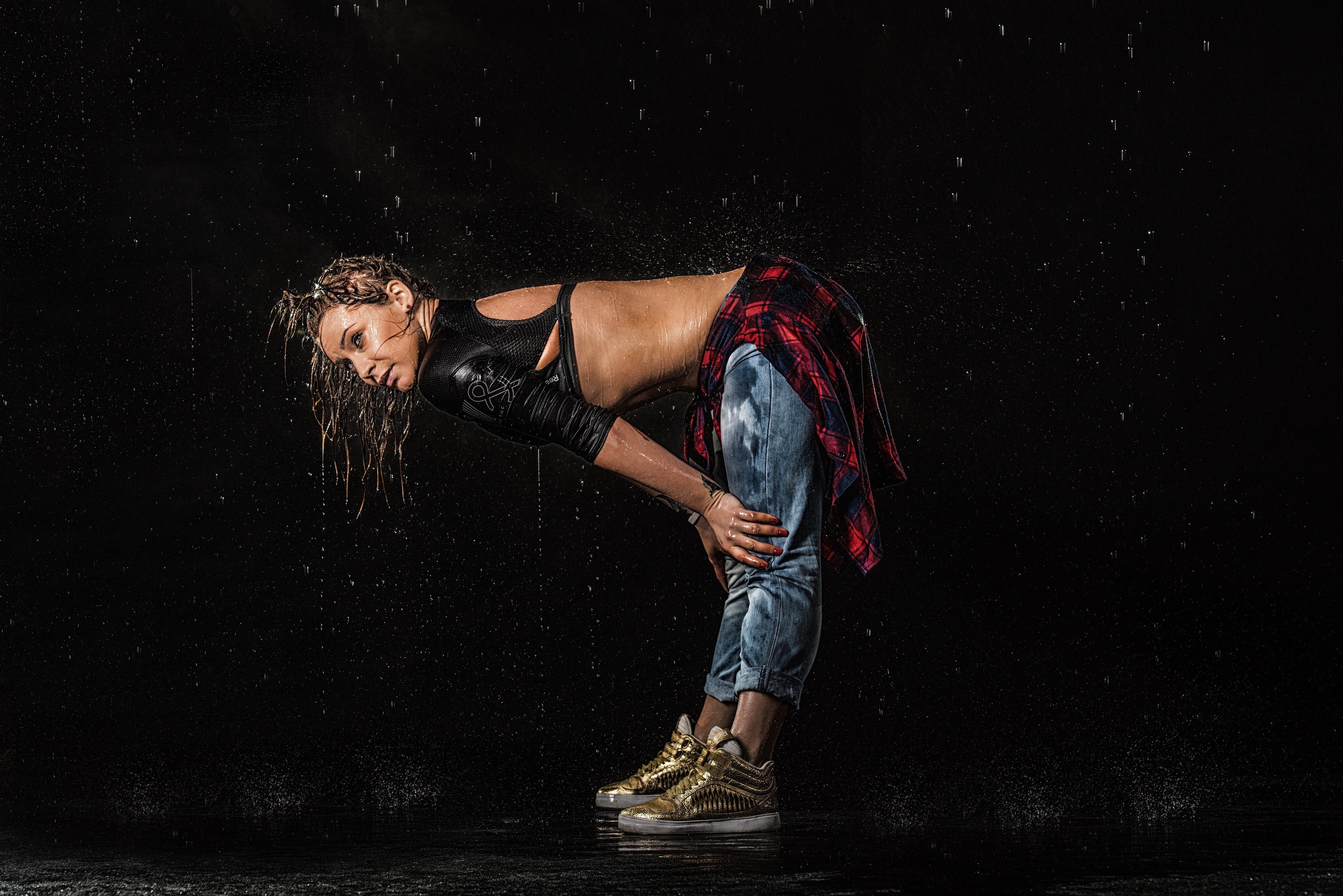 People 3680x2456 women water rain model wet body wet hair wet clothing tattoo wet black background simple background bent over jeans gold shoes