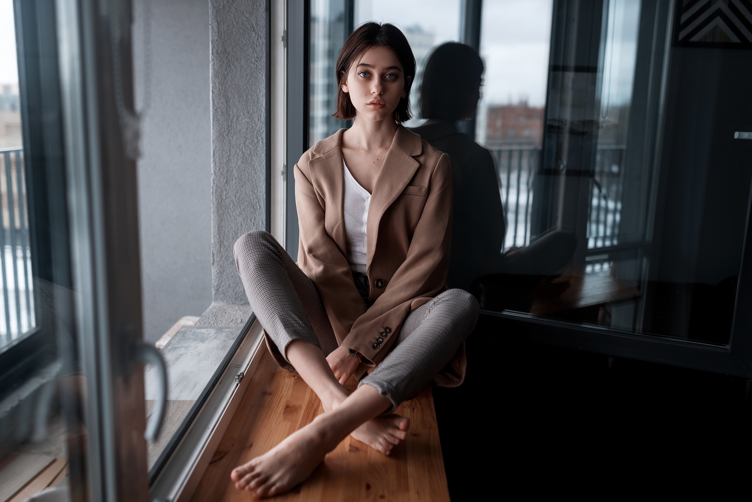 People 2560x1709 women model brunette looking at viewer gray eyes coats blouses white blouse pants sitting legs crossed reflection window bokeh indoors women indoors Juliana Naidenova barefoot feet