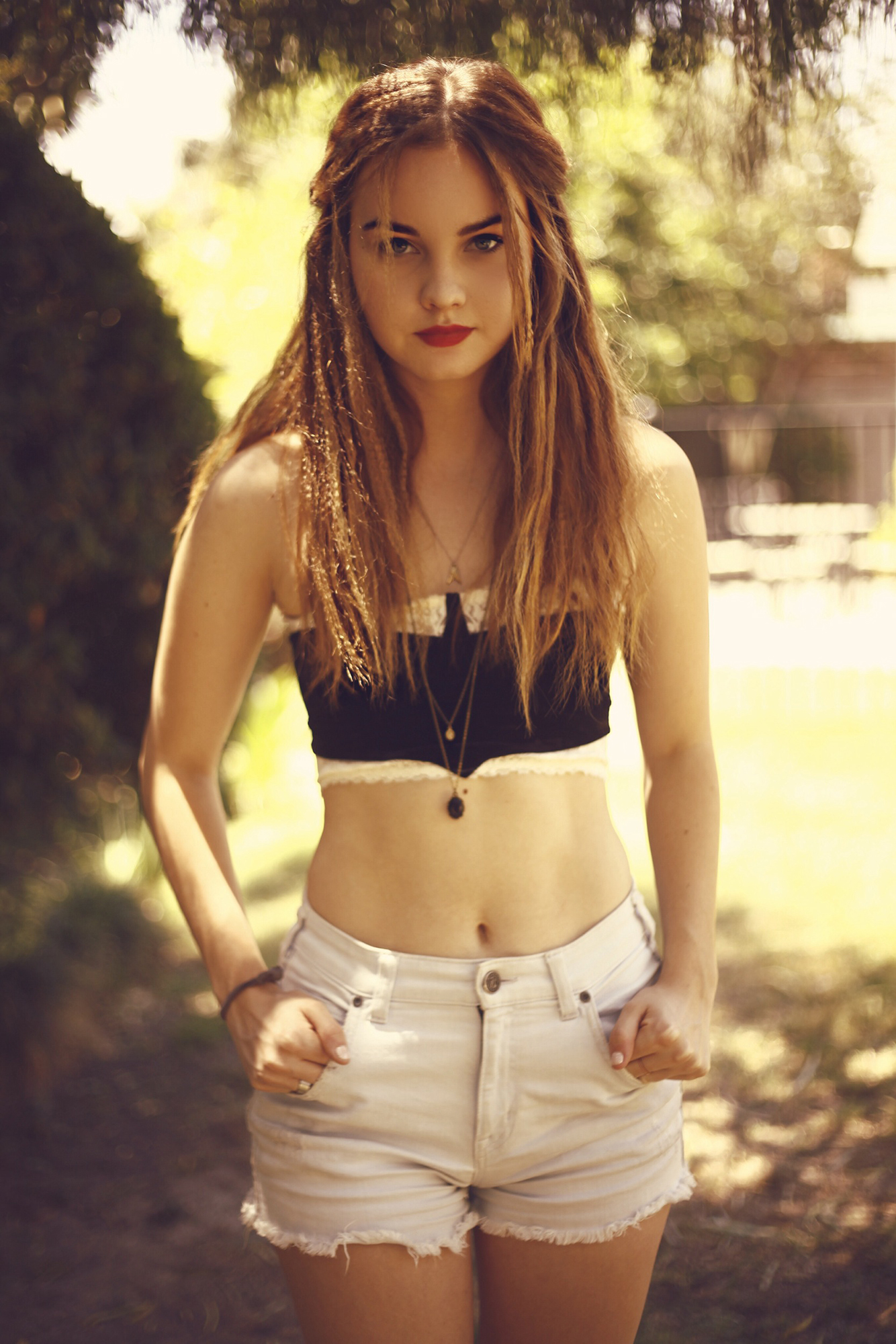 People 1334x2000 Liana Liberato women actress women outdoors looking at viewer shorts hair in face brunette tube top bare shoulders bare midriff hands in pockets bandeau top white shorts