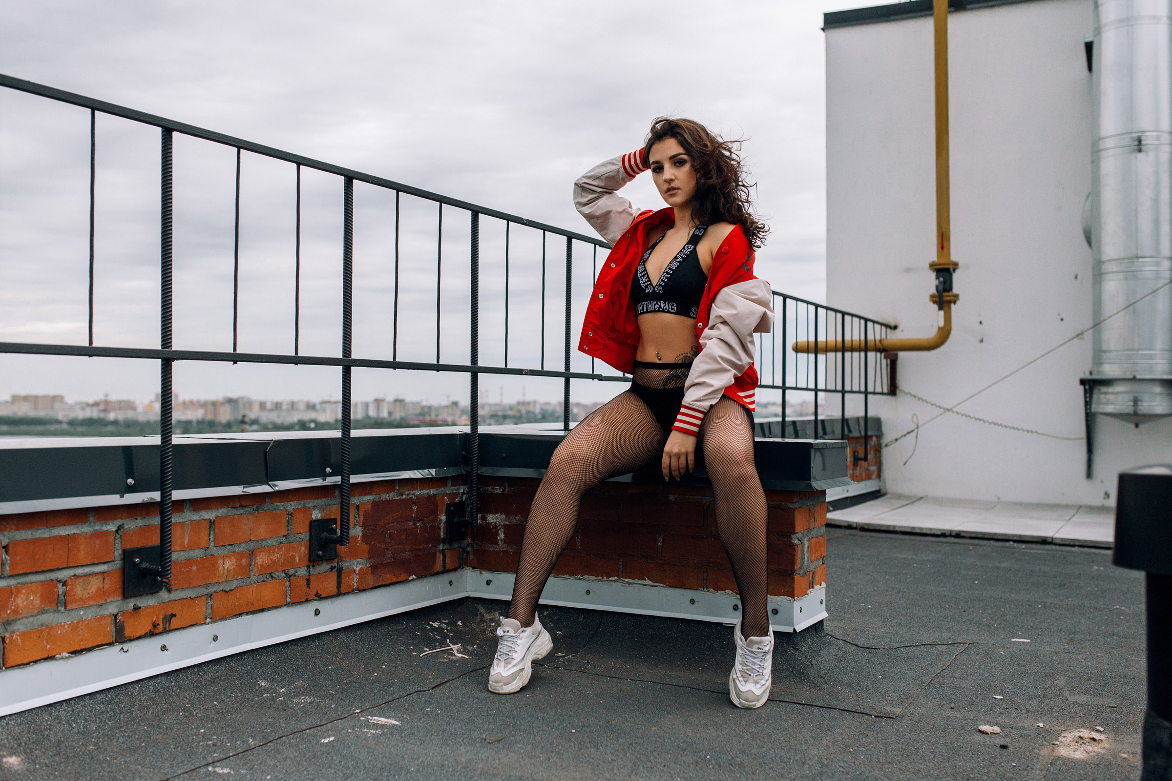 People 2400x1600 women fishnet stockings belly sitting brunette sweater tattoo pierced navel sneakers fence rooftops painted nails bricks cleavage