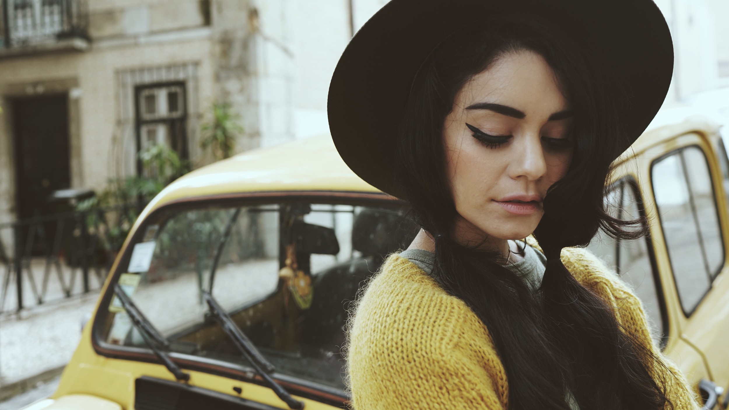 People 2500x1406 women women with cars Vanessa Hudgens celebrity actress car yellow cars dark hair women outdoors urban hat women with hats vehicle sweater yellow sweater