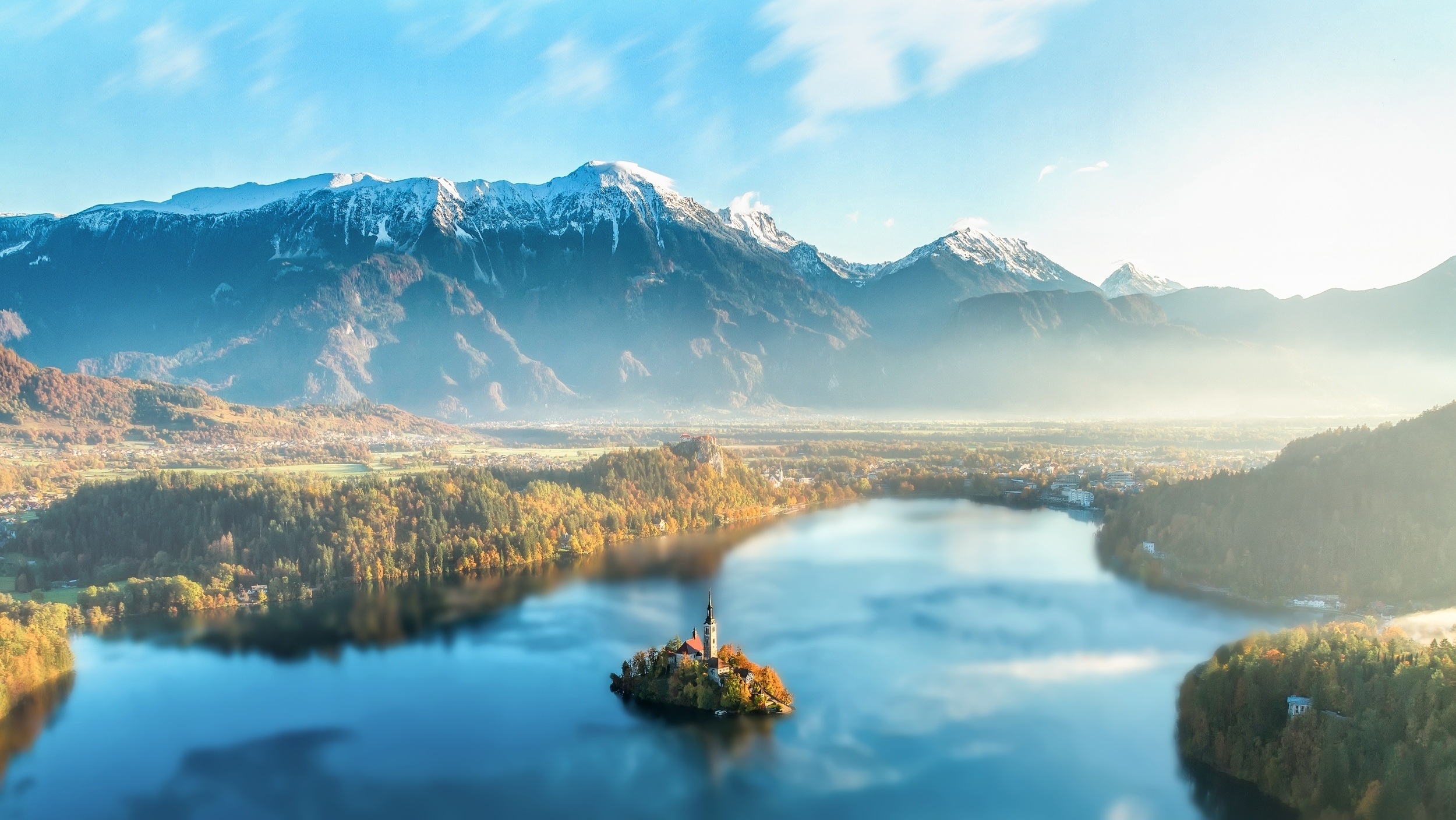 General 2500x1408 landscape lake Slovenia Lake Bled forest mist church snowy peak mountains clouds dawn hills nature outdoors reflection pine trees snow sunset water cyan island sky aerial view
