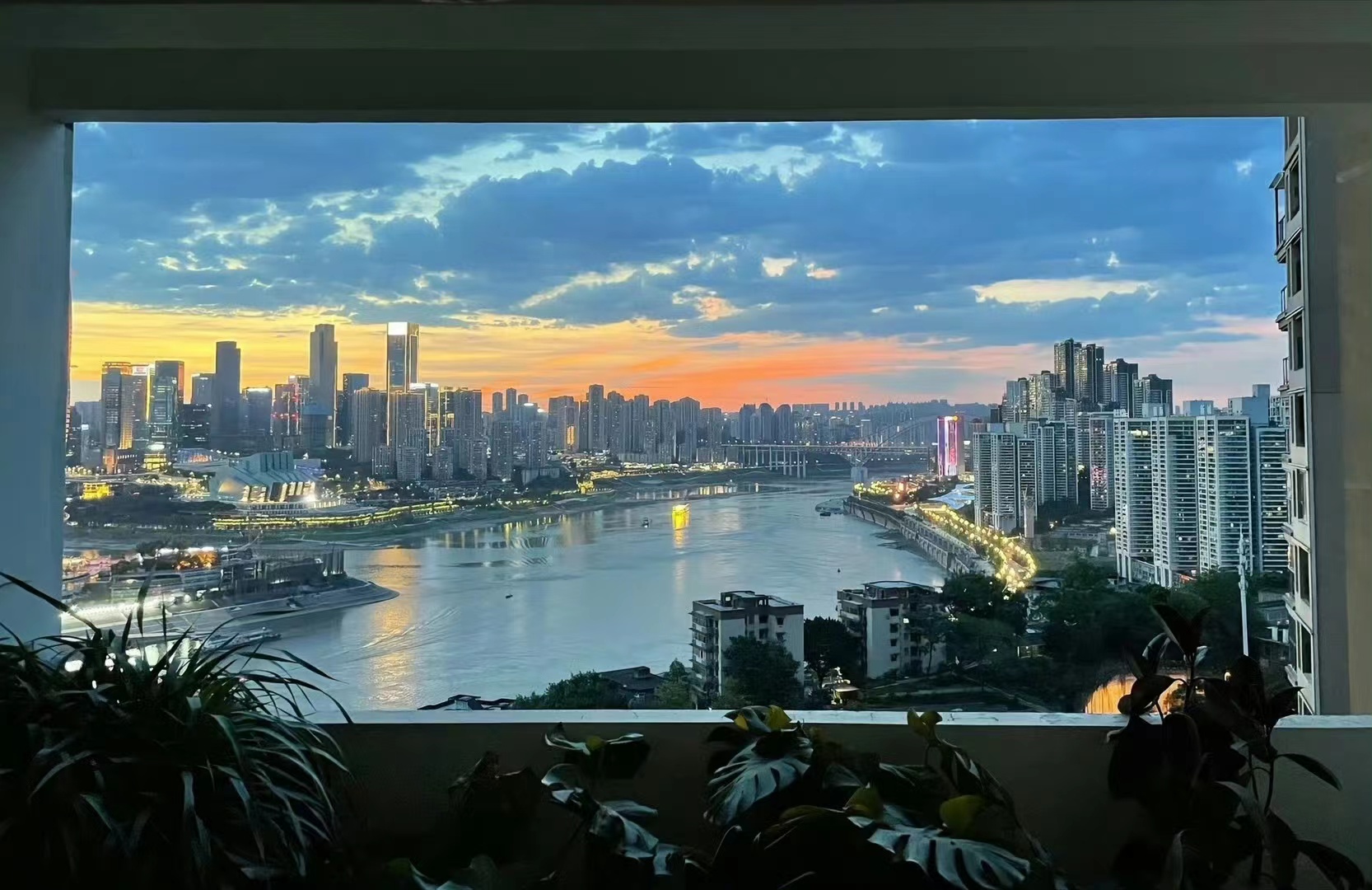 General 1666x1080 city window shade sunset sunset glow water sky clouds leaves building cityscape city lights