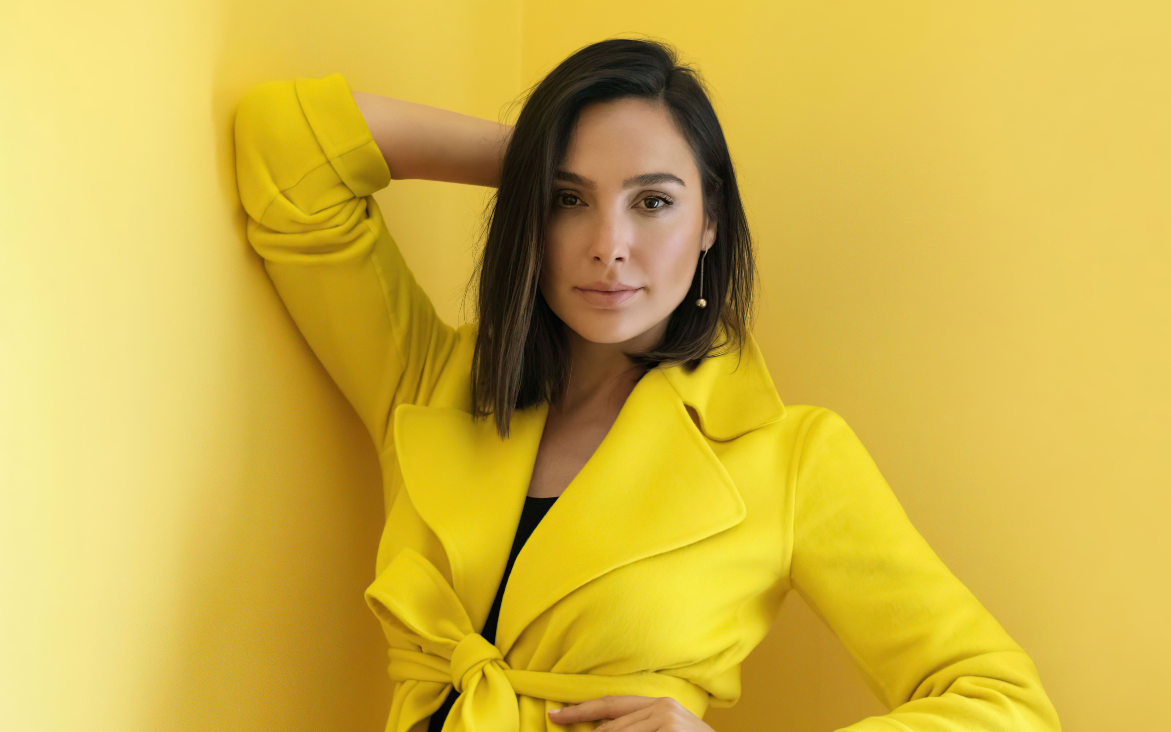 People 3840x2400 women model actress Gal Gadot studio yellow yellow background yellow clothing dark hair looking at viewer women indoors indoors yellow coats simple background by the wall brown eyes portrait