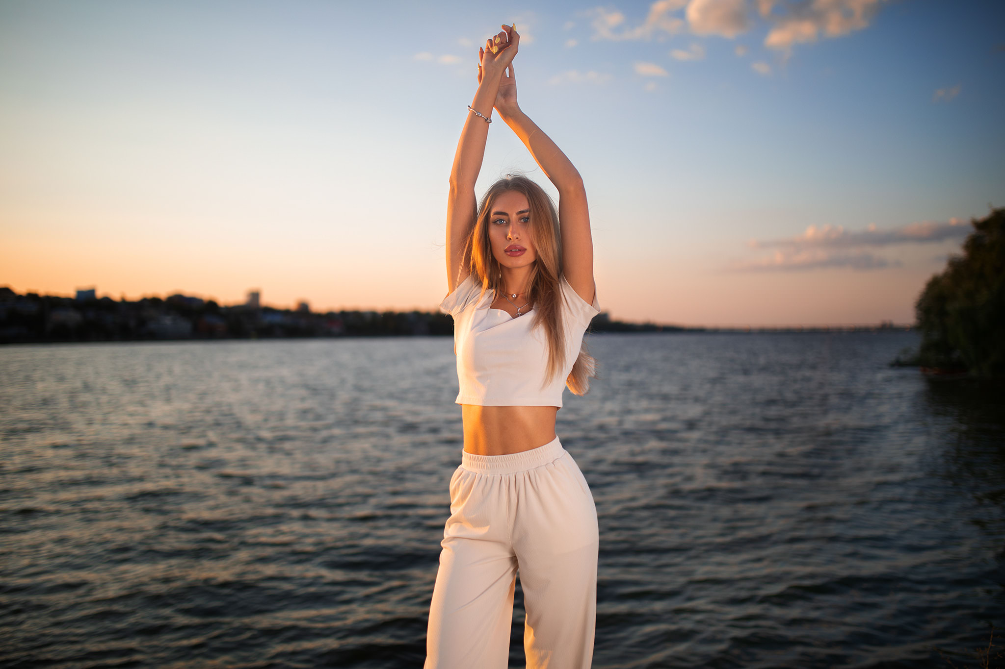 People 2048x1365 women blonde Dmitry Shulgin arms up river sunset women outdoors white clothing crucifix necklace blue eyes sky clouds T-shirt